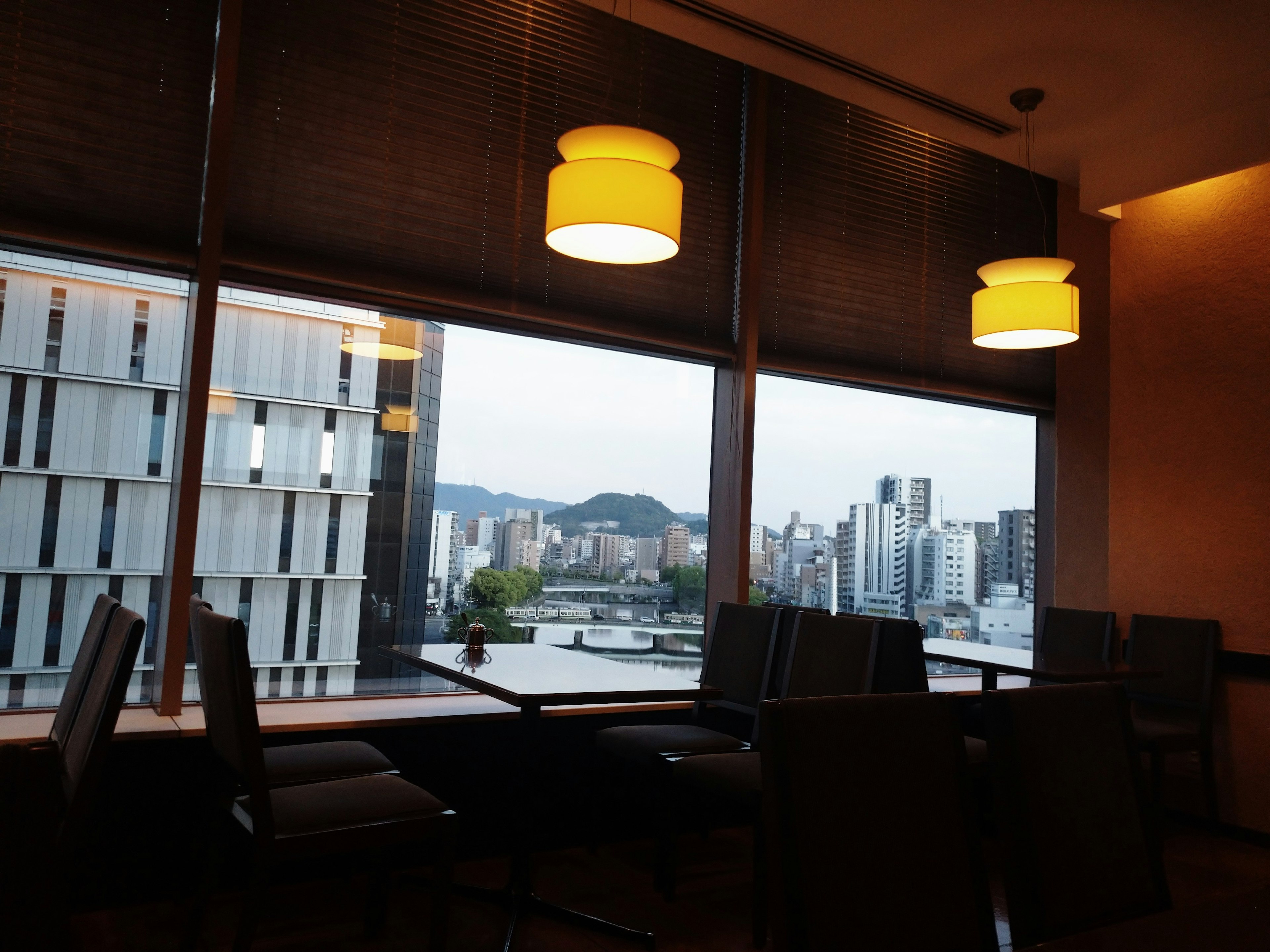 Interior of a cafe with bright lighting and a view of the city