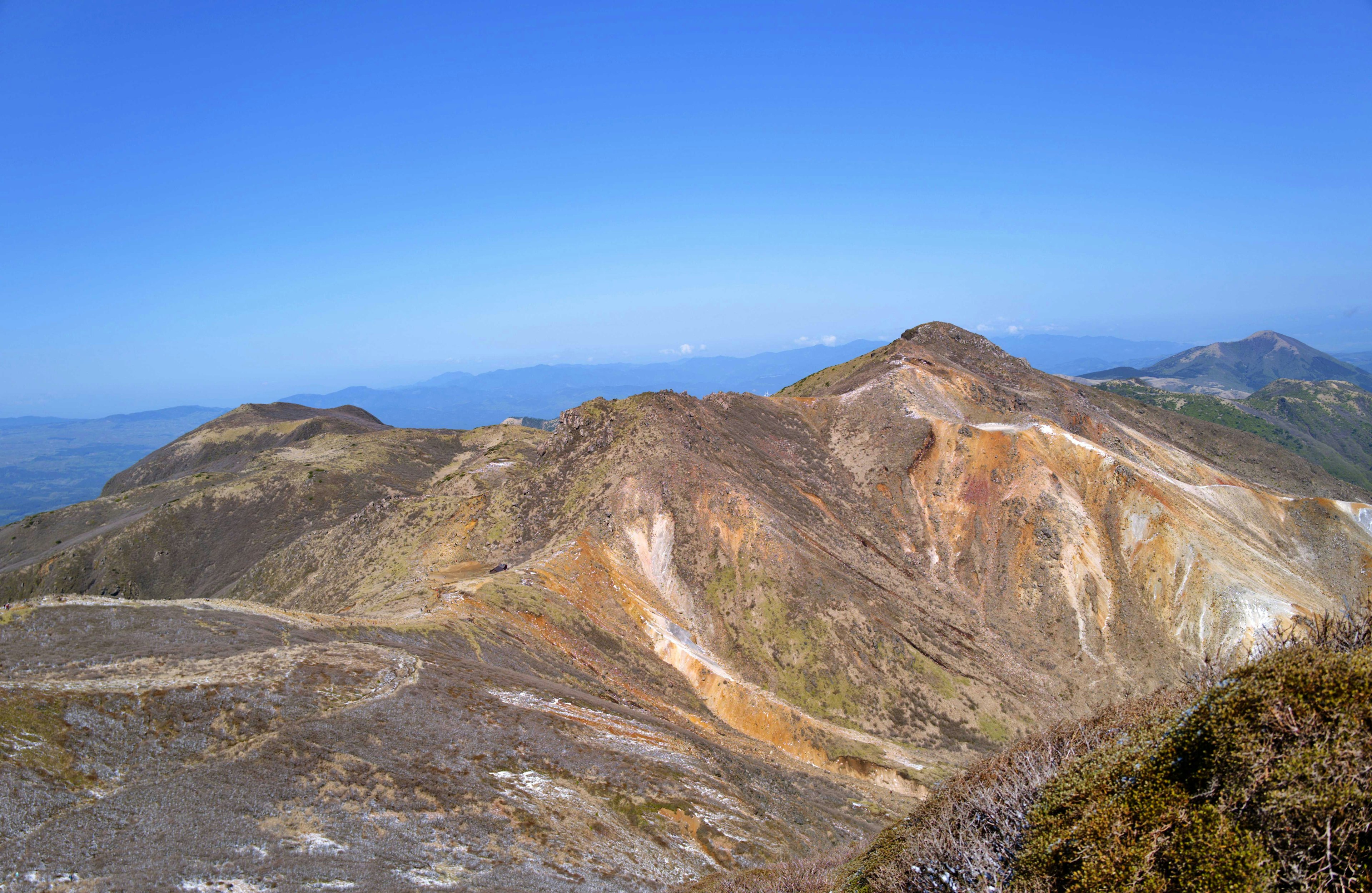 Scenic view of mountains under a clear blue sky