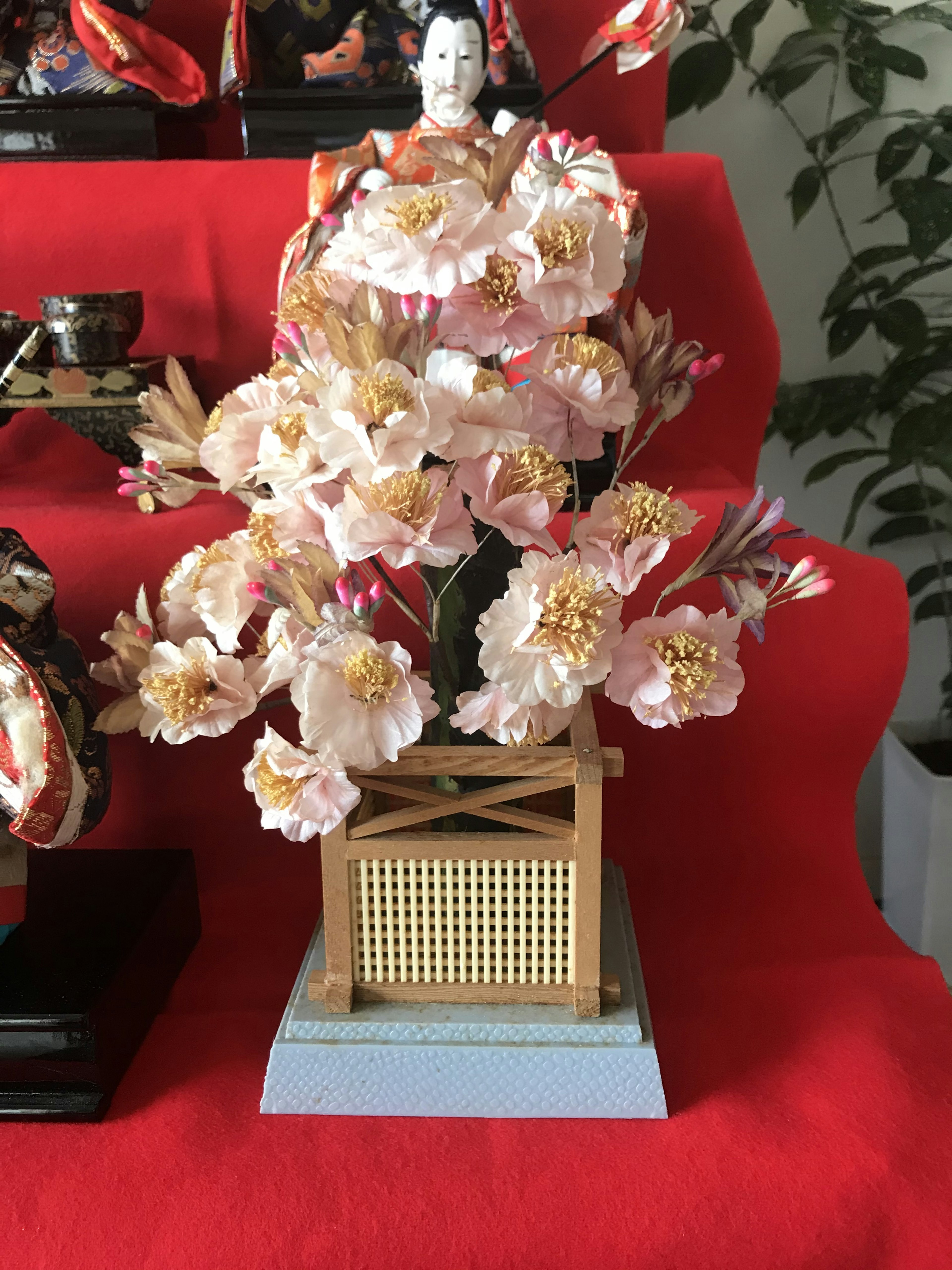 Traditional Japanese flower arrangement featuring pink flowers in a decorative vase