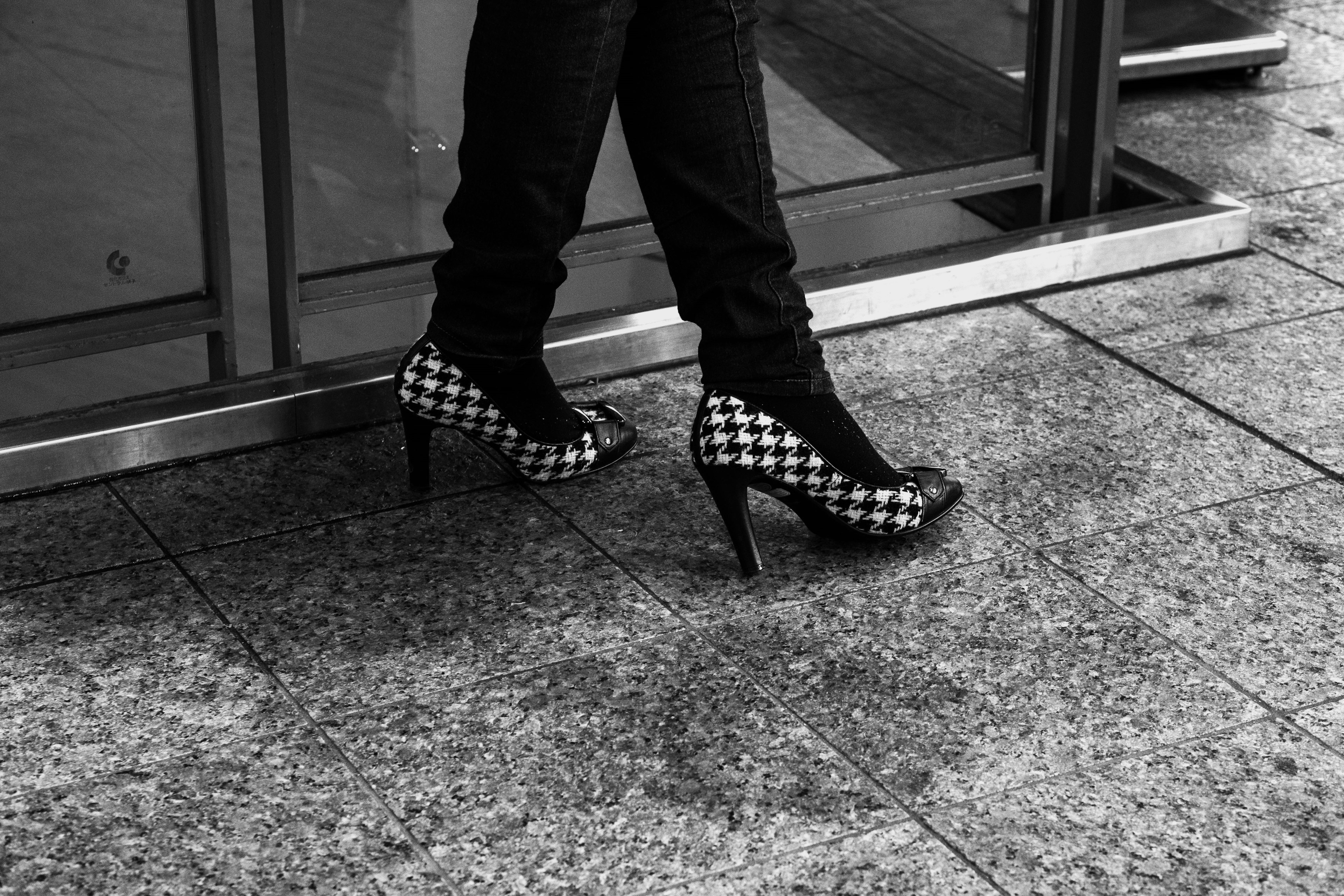 Close-up of a woman wearing black and white checkered high heels