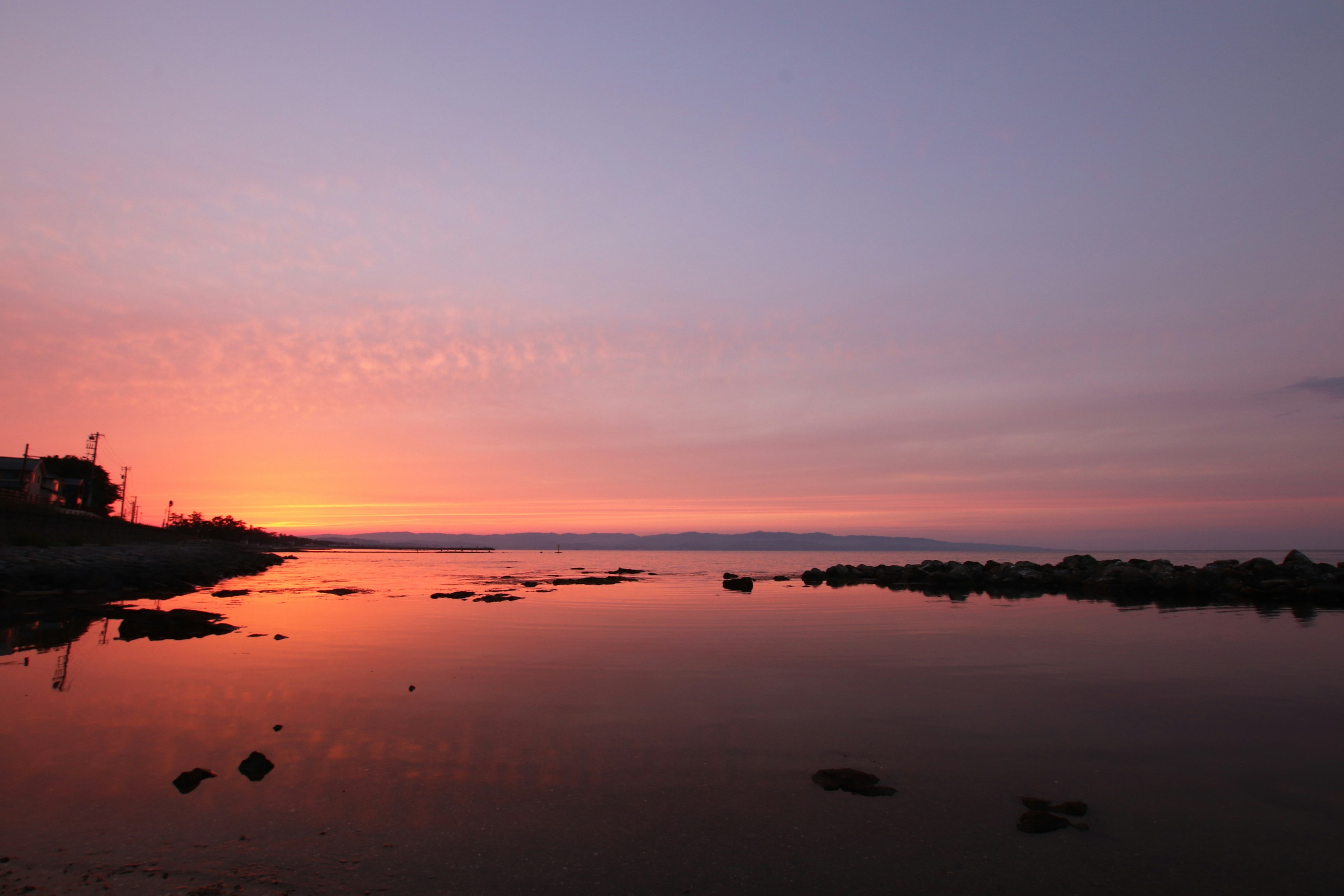 Serene coastal landscape with sunset reflection