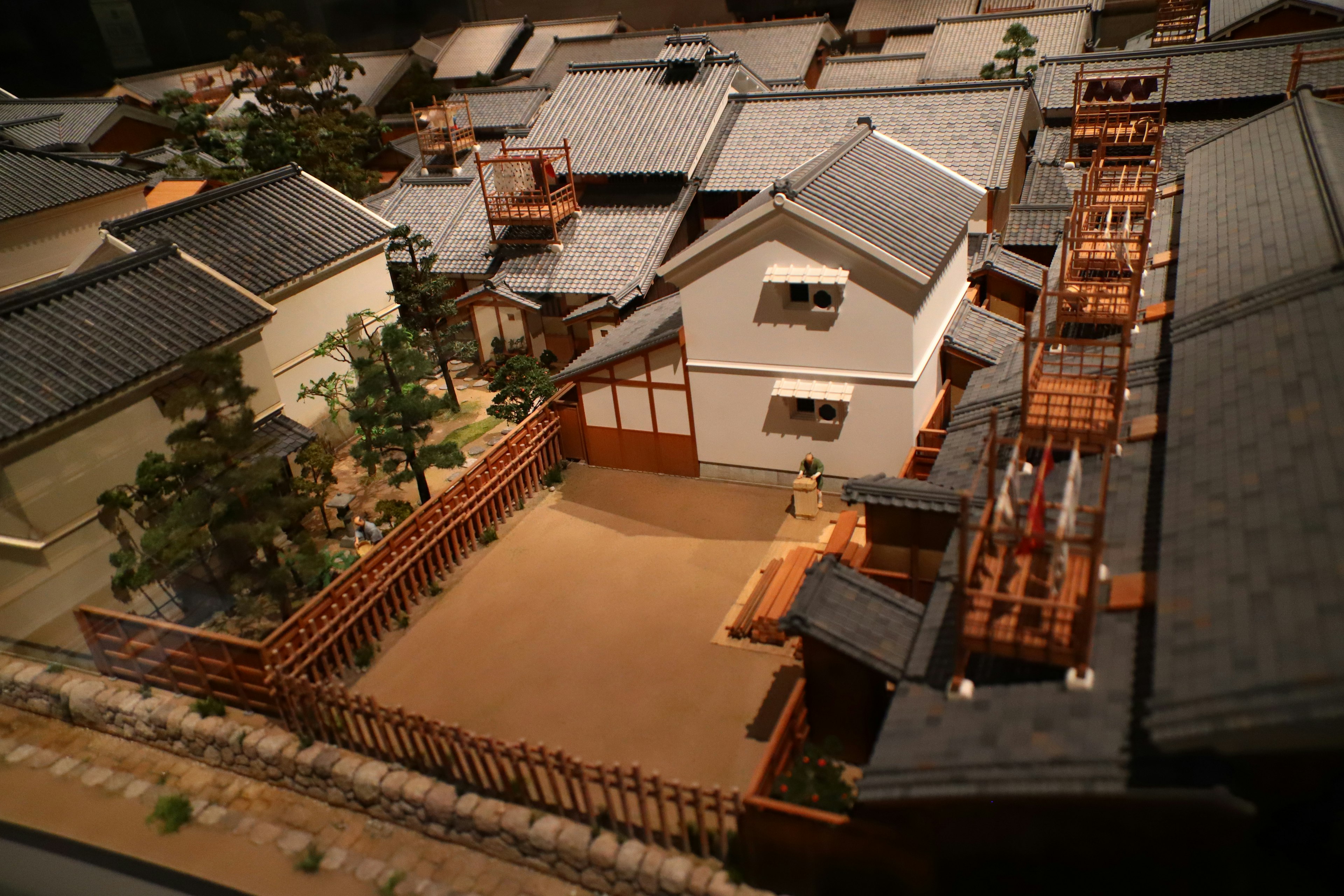 Model of a traditional Japanese town featuring wooden balconies and a garden