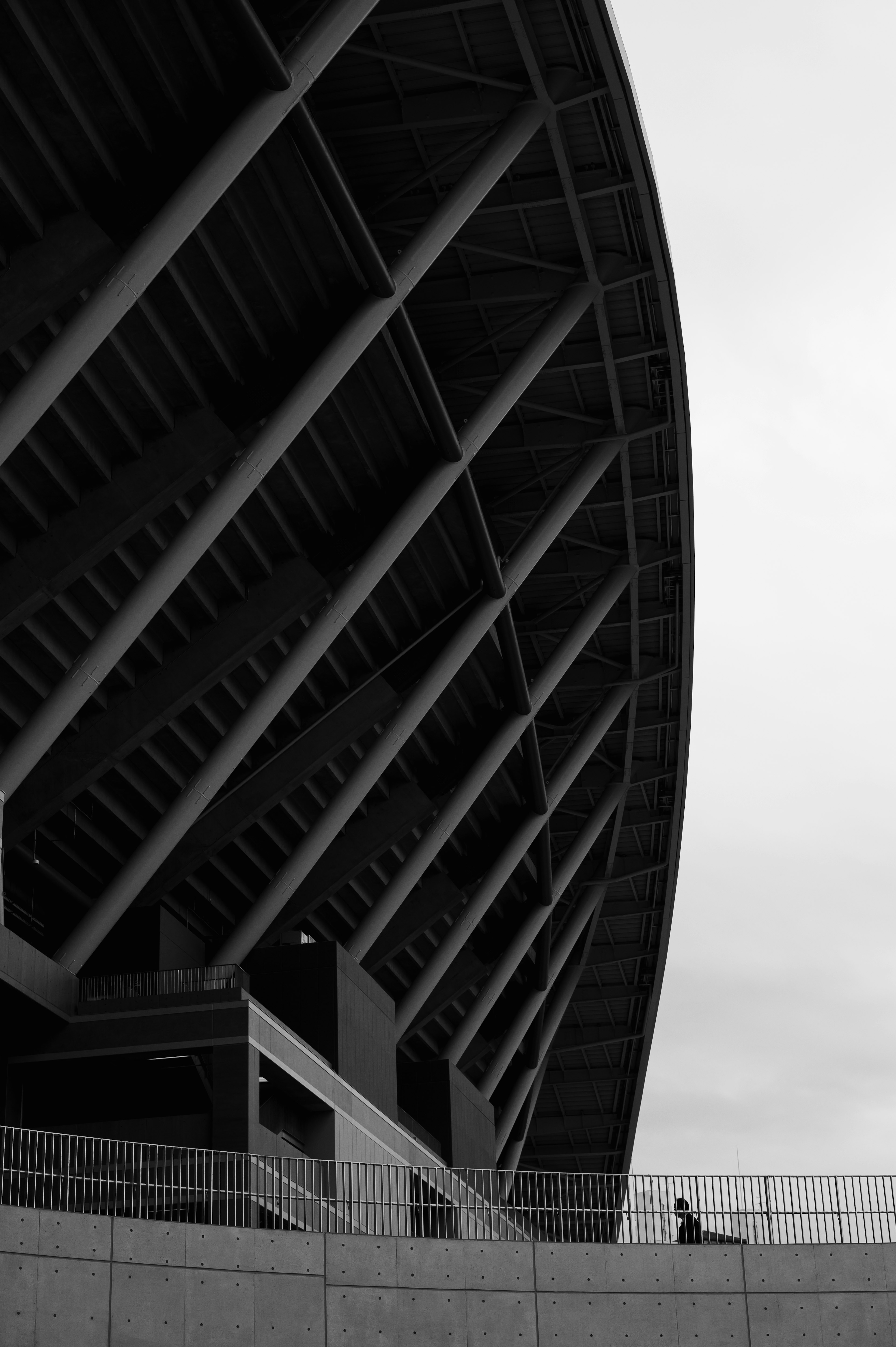 Close-up of a black and white stadium structure with a person