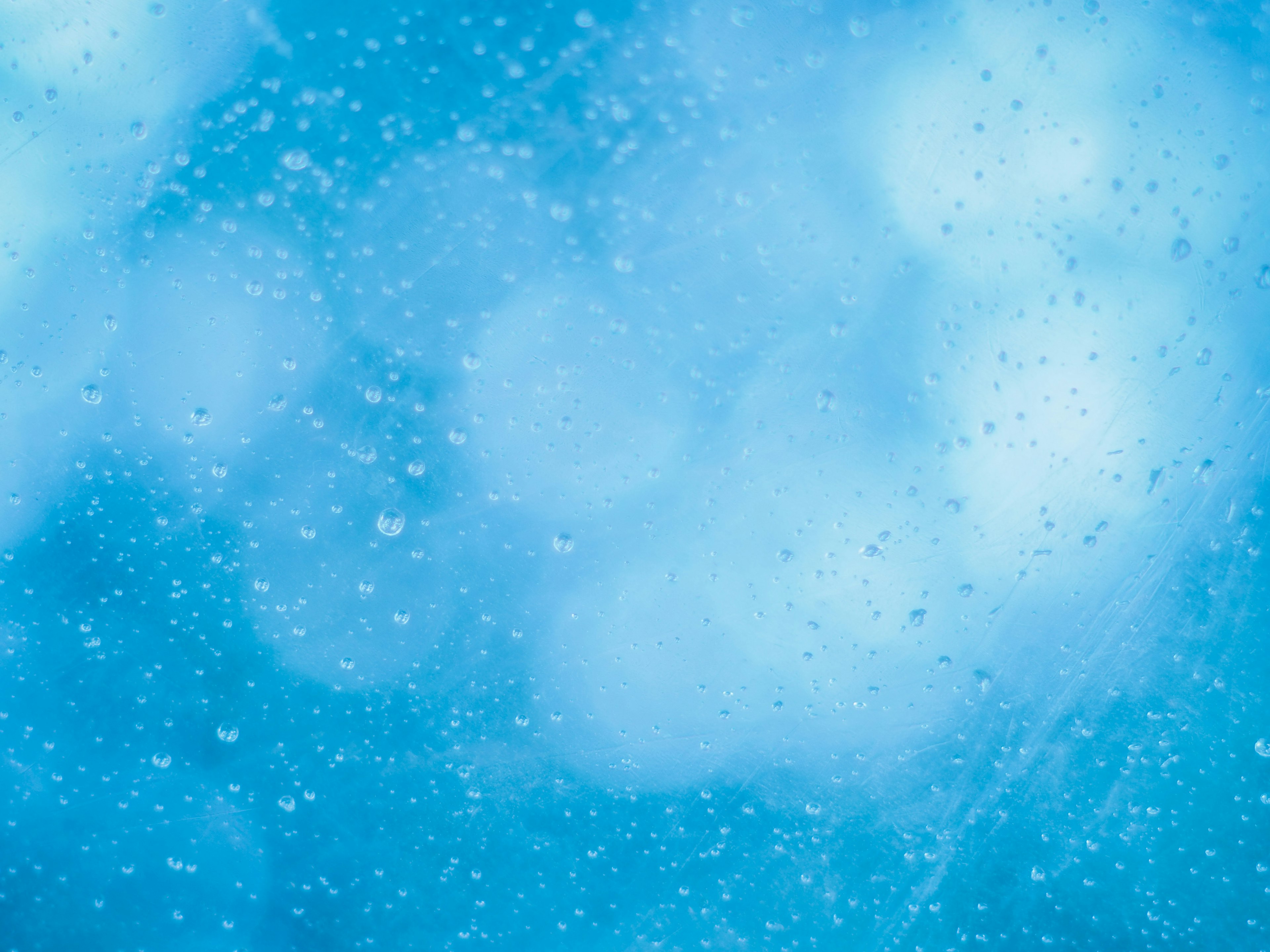 Blurred image with water droplets on a blue background