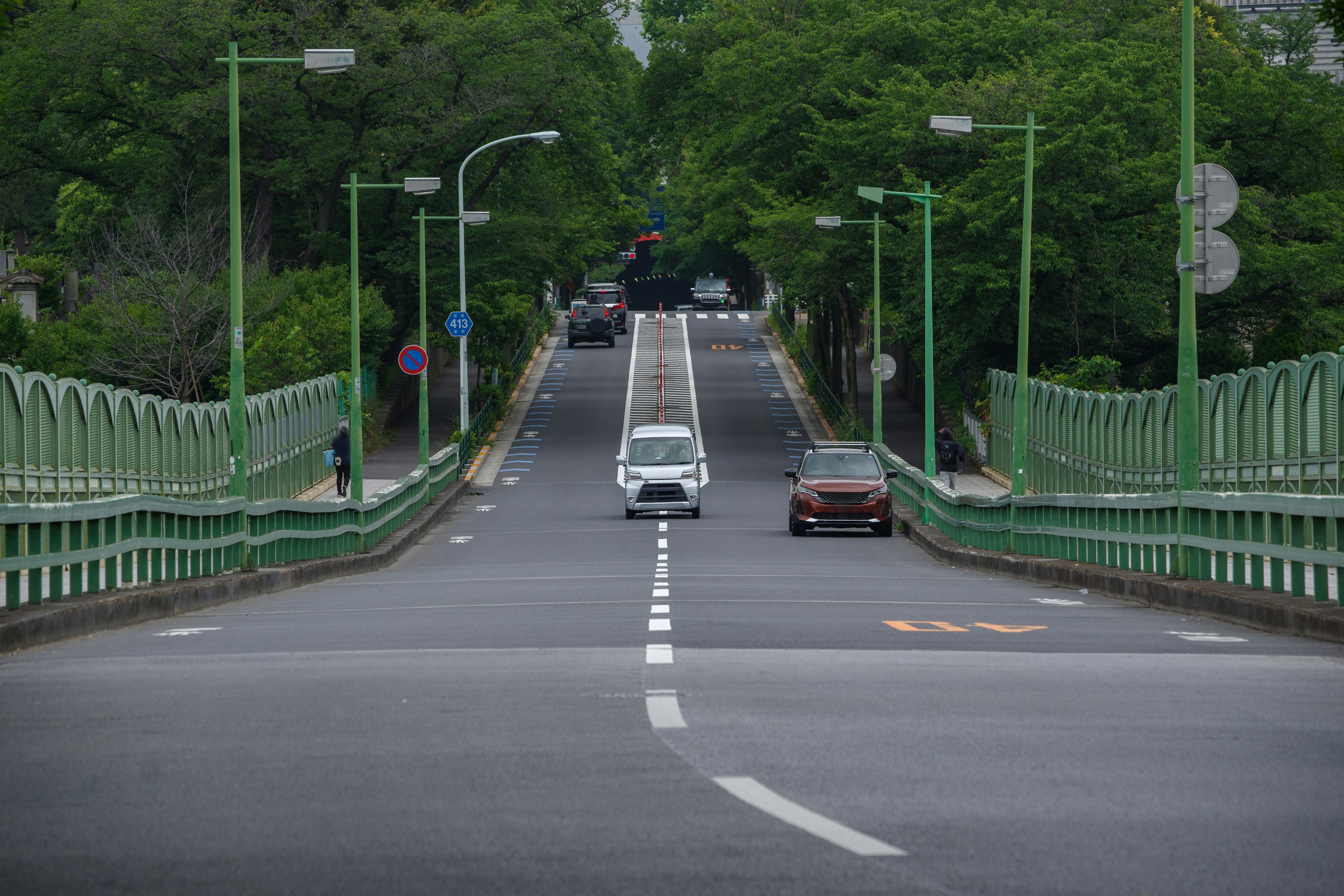 Una vista de un puente verde con coches en la carretera