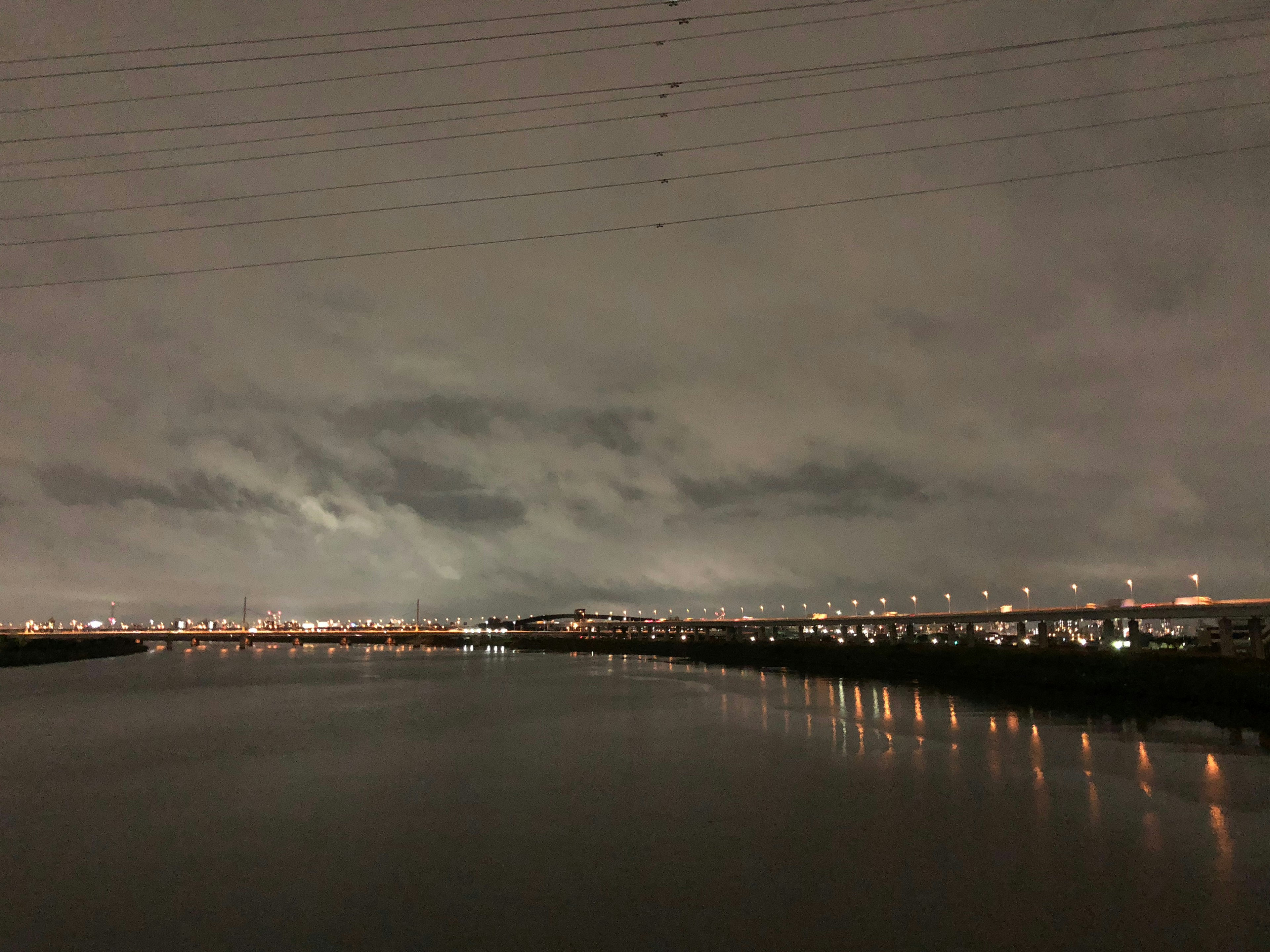 寧靜的夜晚河流反射城市燈光的景觀