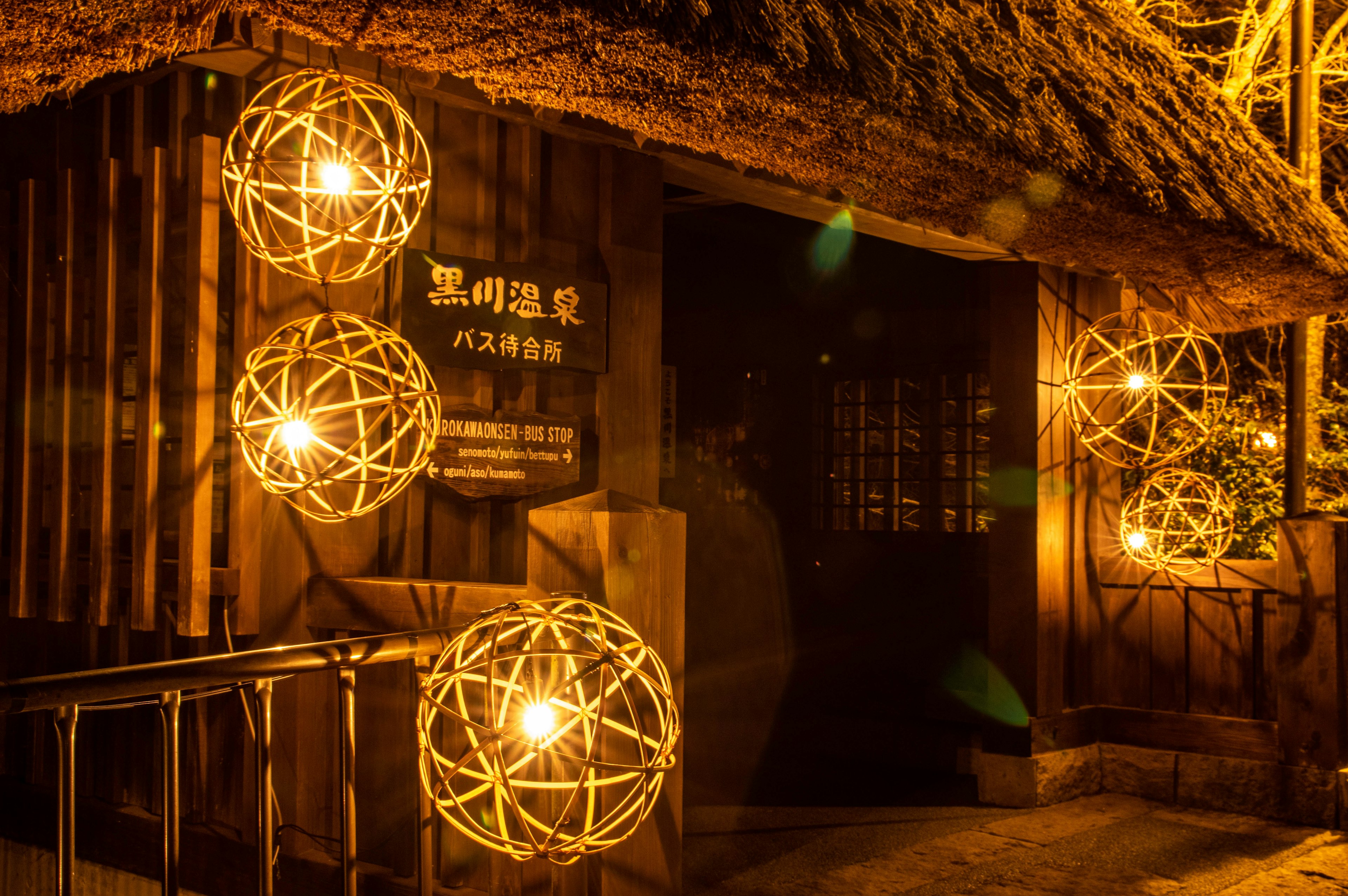 Wooden building illuminated by warm lights with decorative lamps