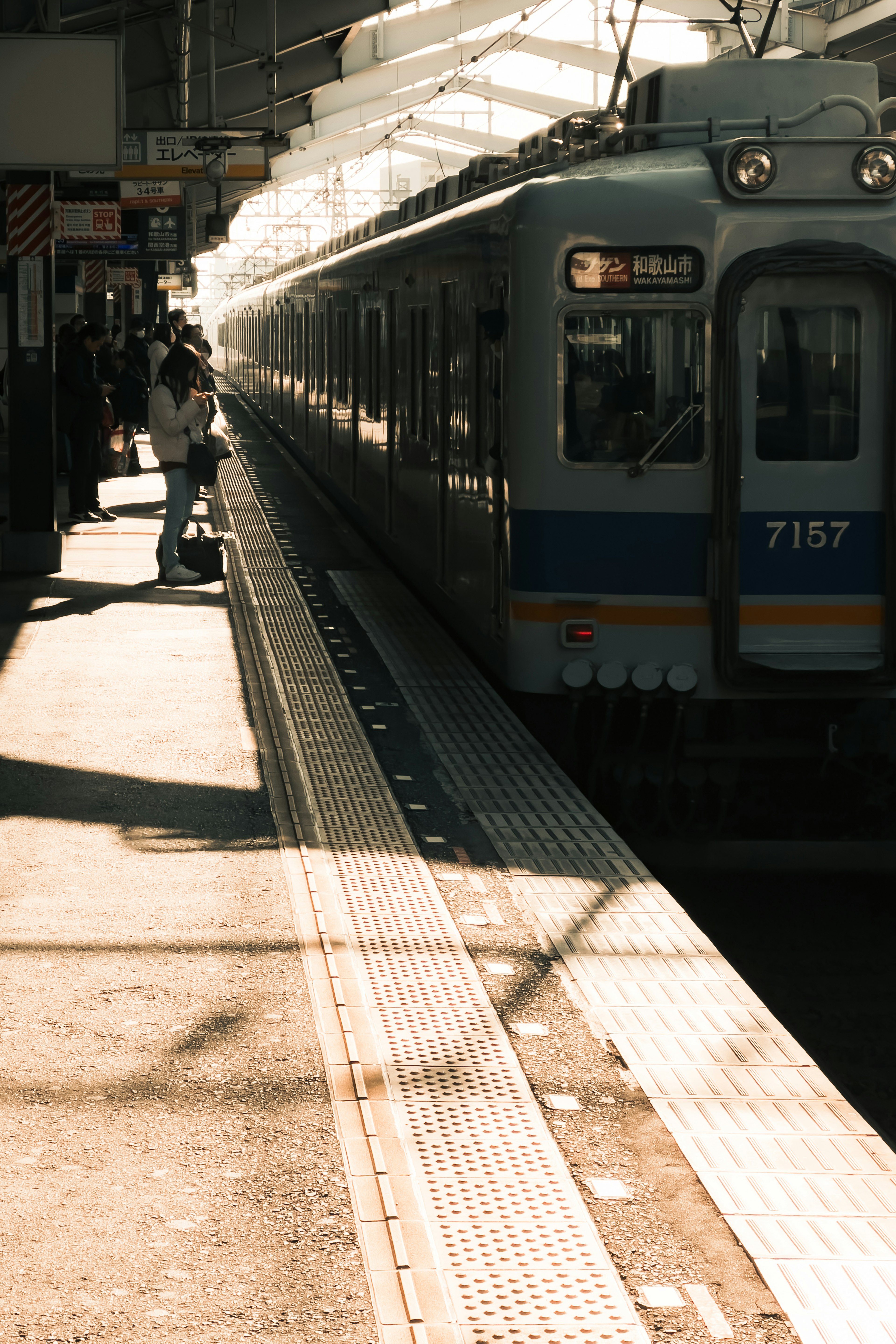 Train at a station platform with shadows and sunlight