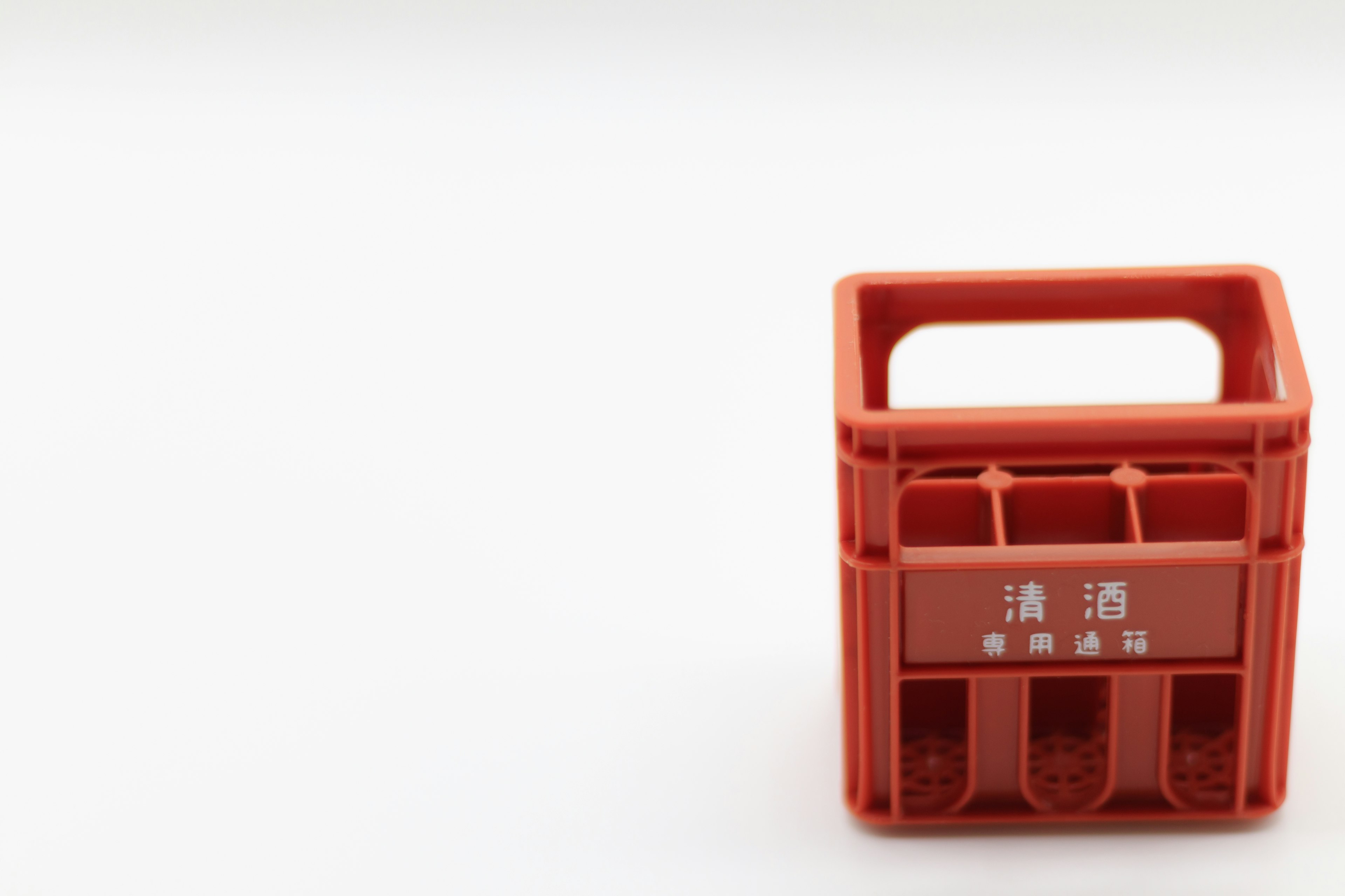 Red plastic crate designed for carrying beverages