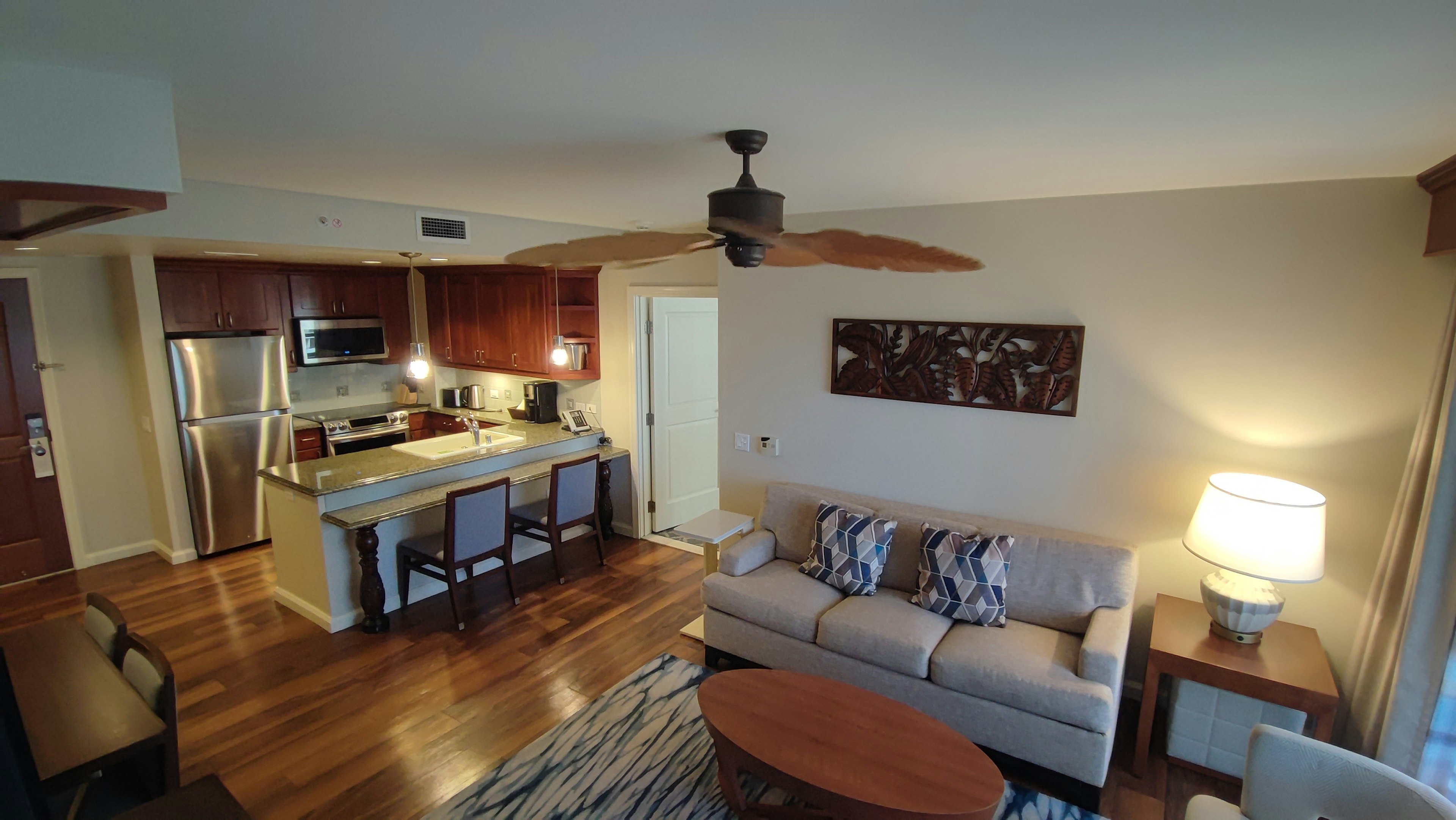 Spacious living room and kitchen interior Warm color tones and wooden furniture Simple modern design