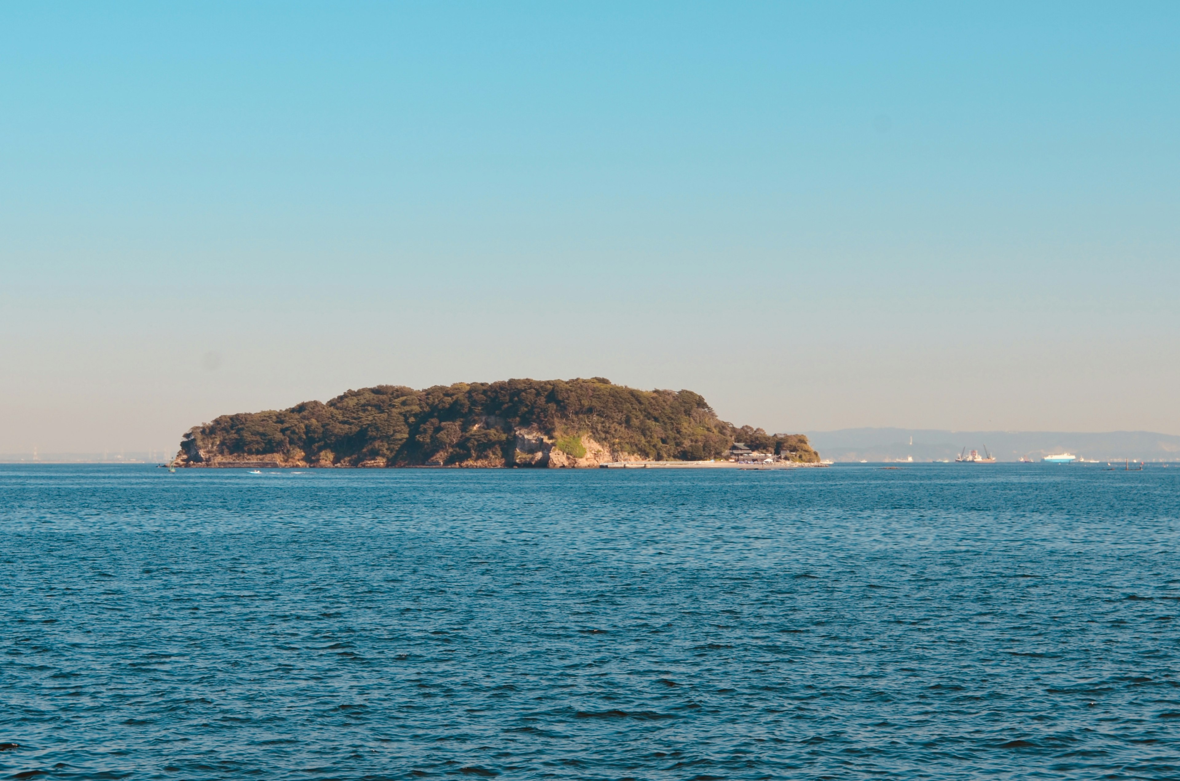 A small island floating in a blue sea