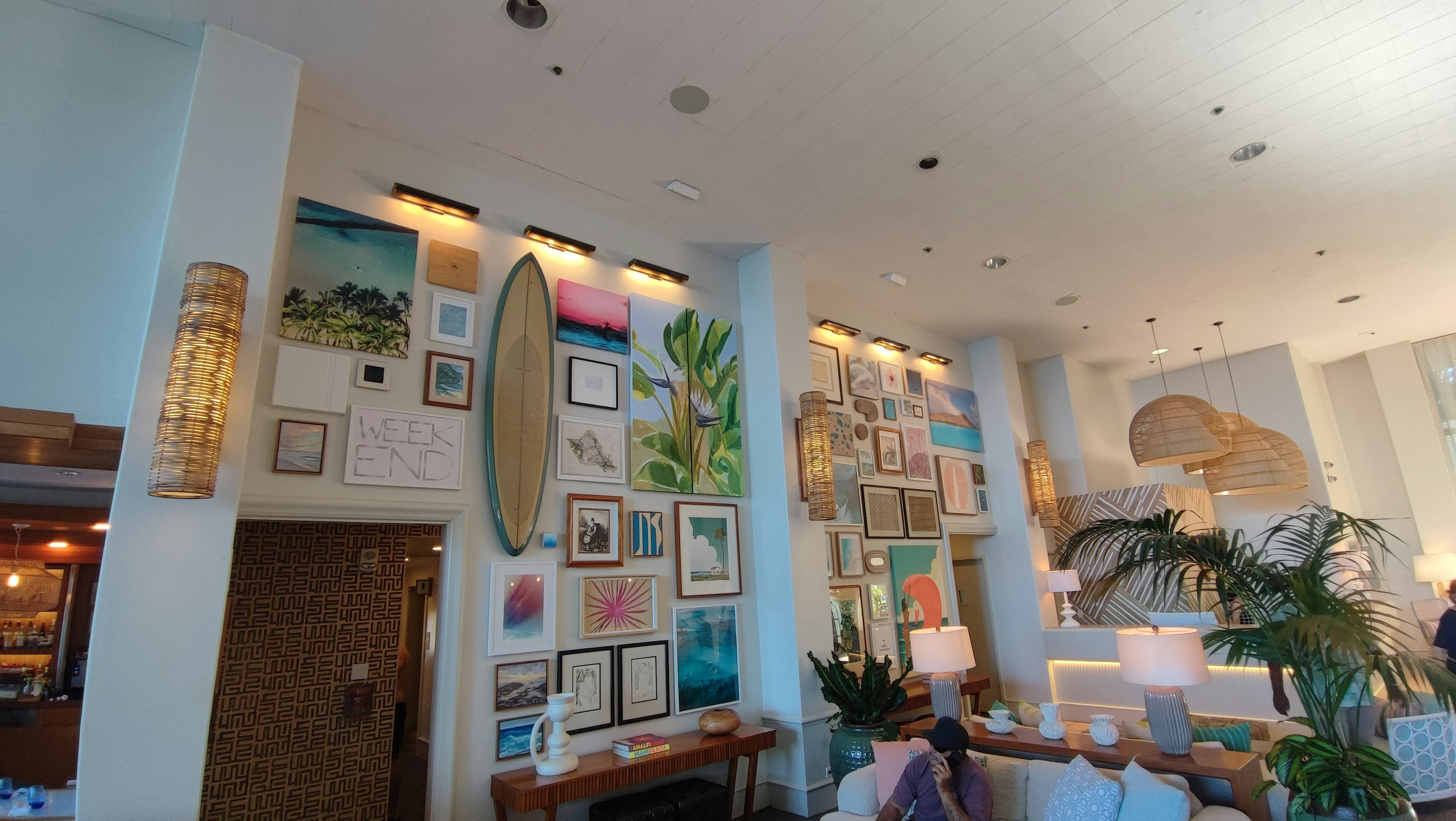 Modern lobby interior featuring bright artwork and decorative plants