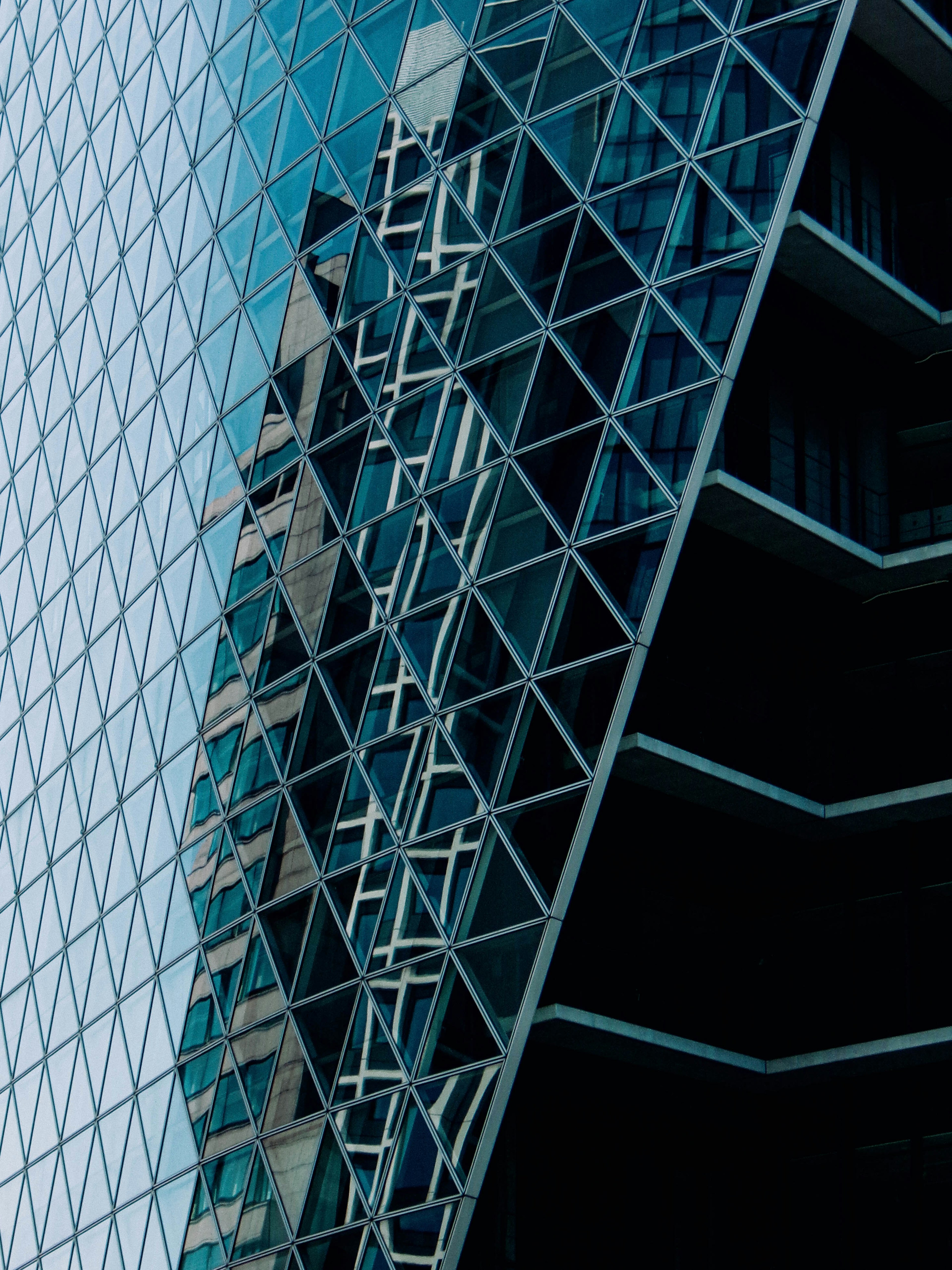 Façade moderne d'un bâtiment avec motif triangulaire en verre