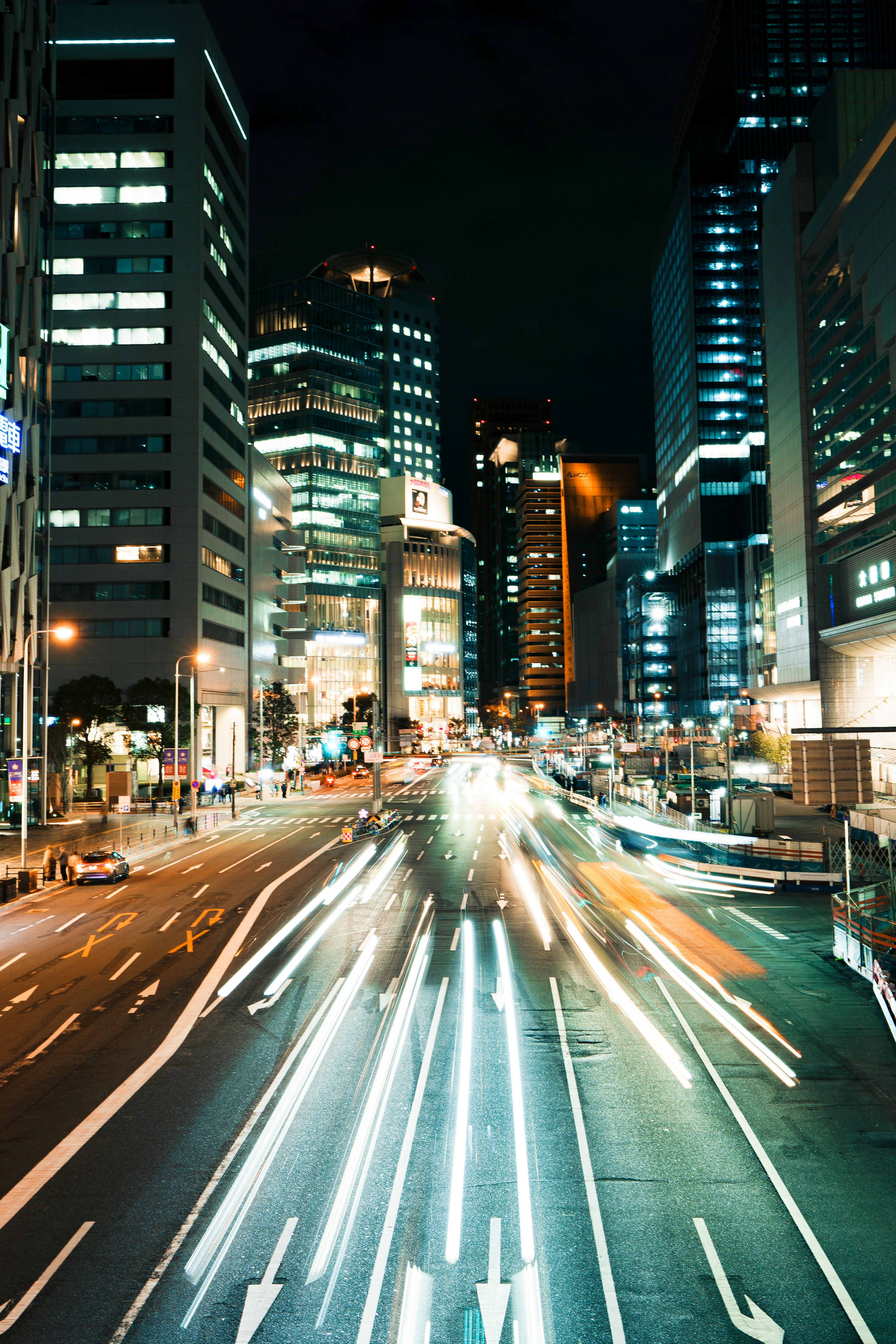 Night cityscape with flowing car light trails