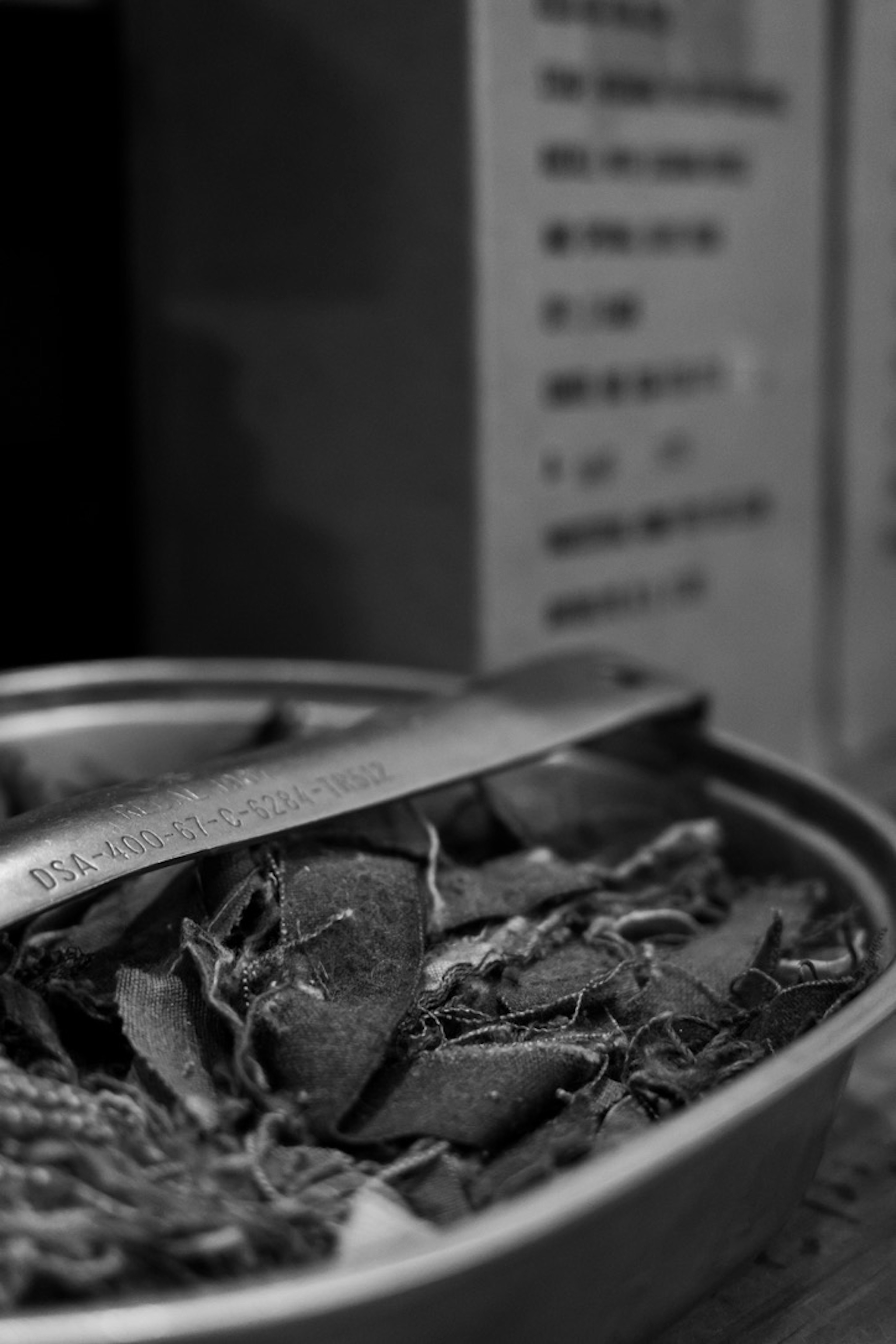 Black and white image featuring dried herbs and a spoon