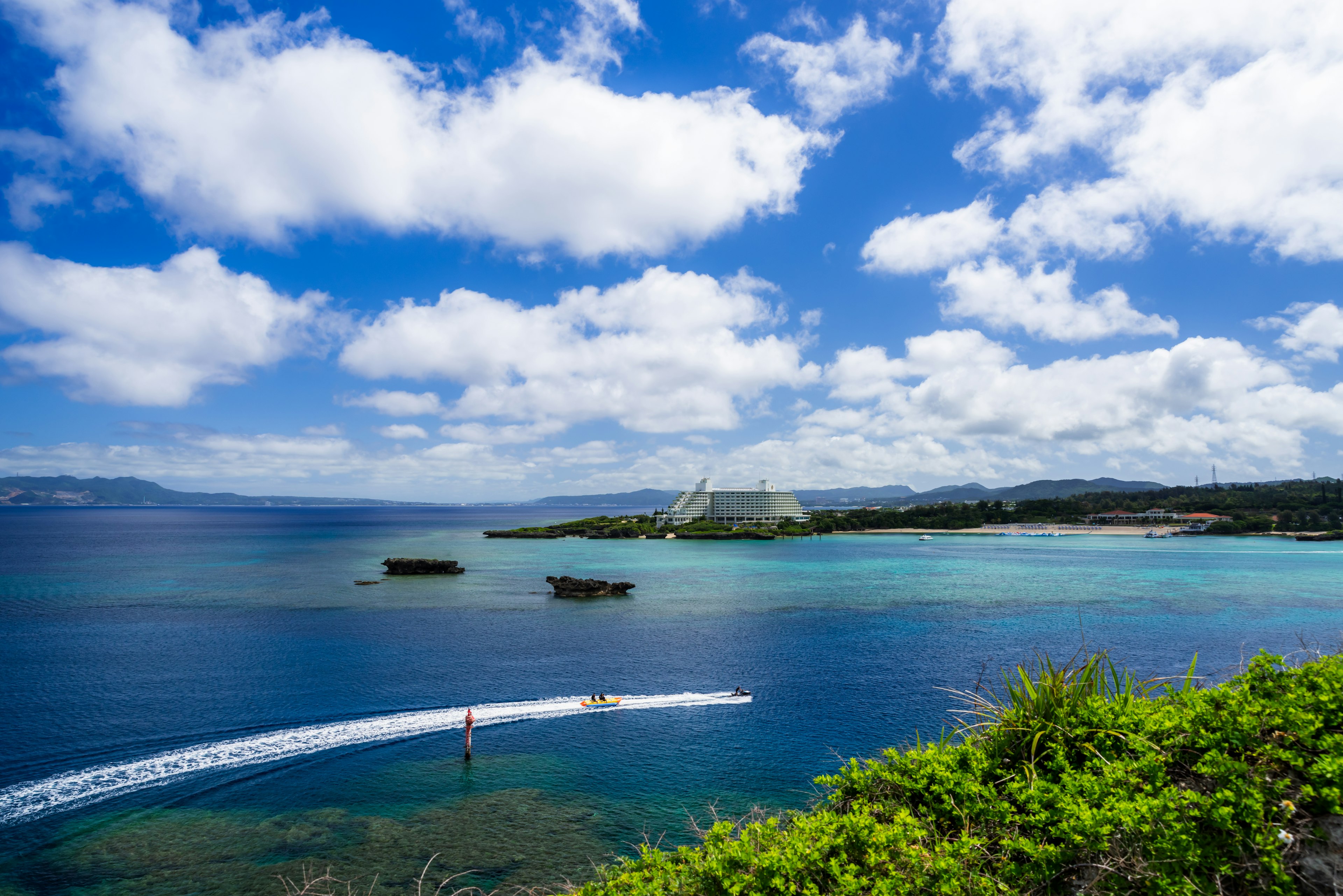 A beautiful landscape with blue sea and sky featuring boats