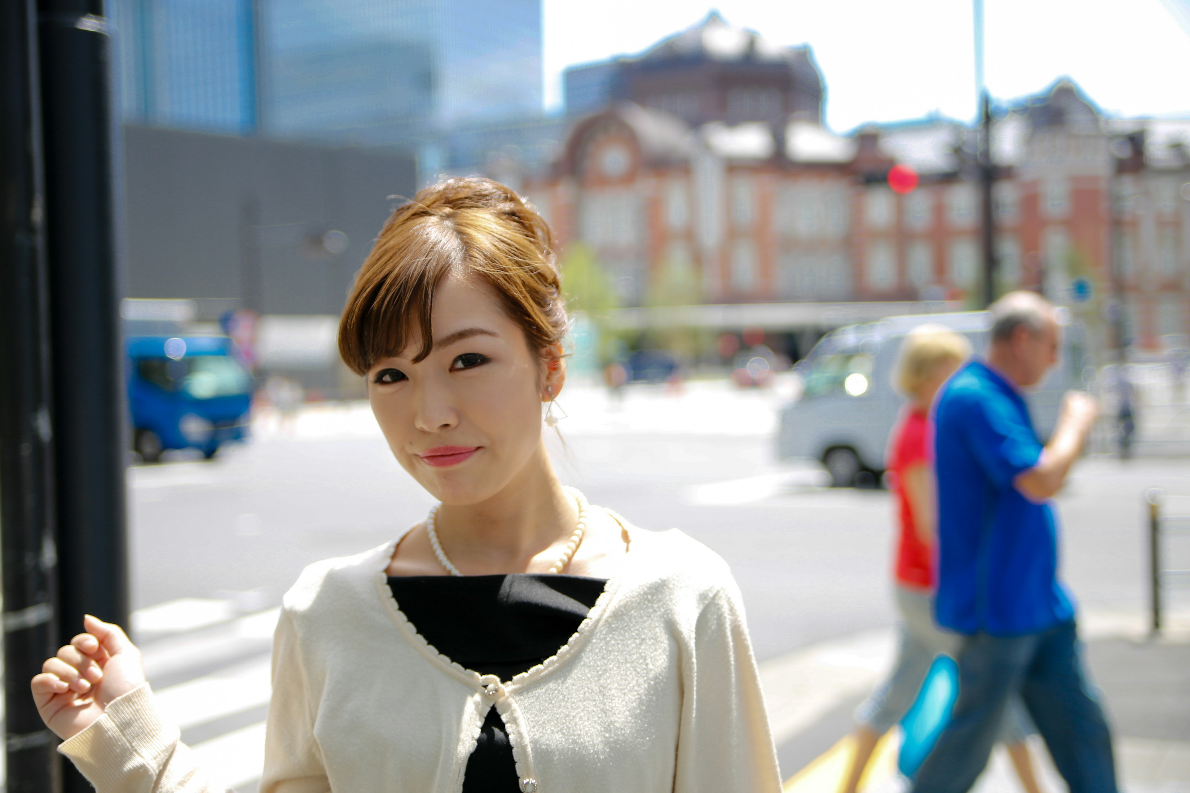 Portrait of a woman at a street corner with a city background