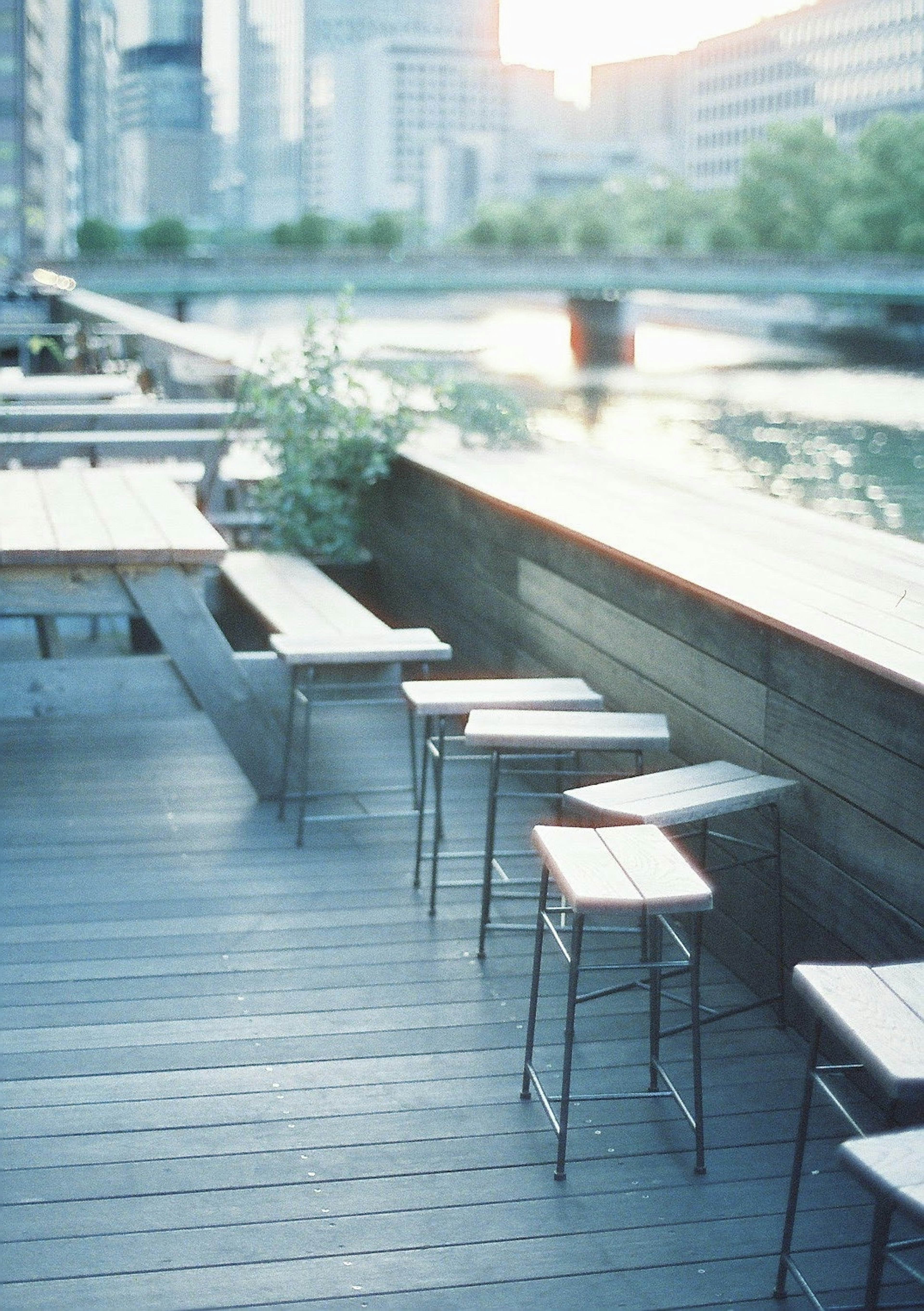 Steel chairs and tables arranged on a riverside terrace