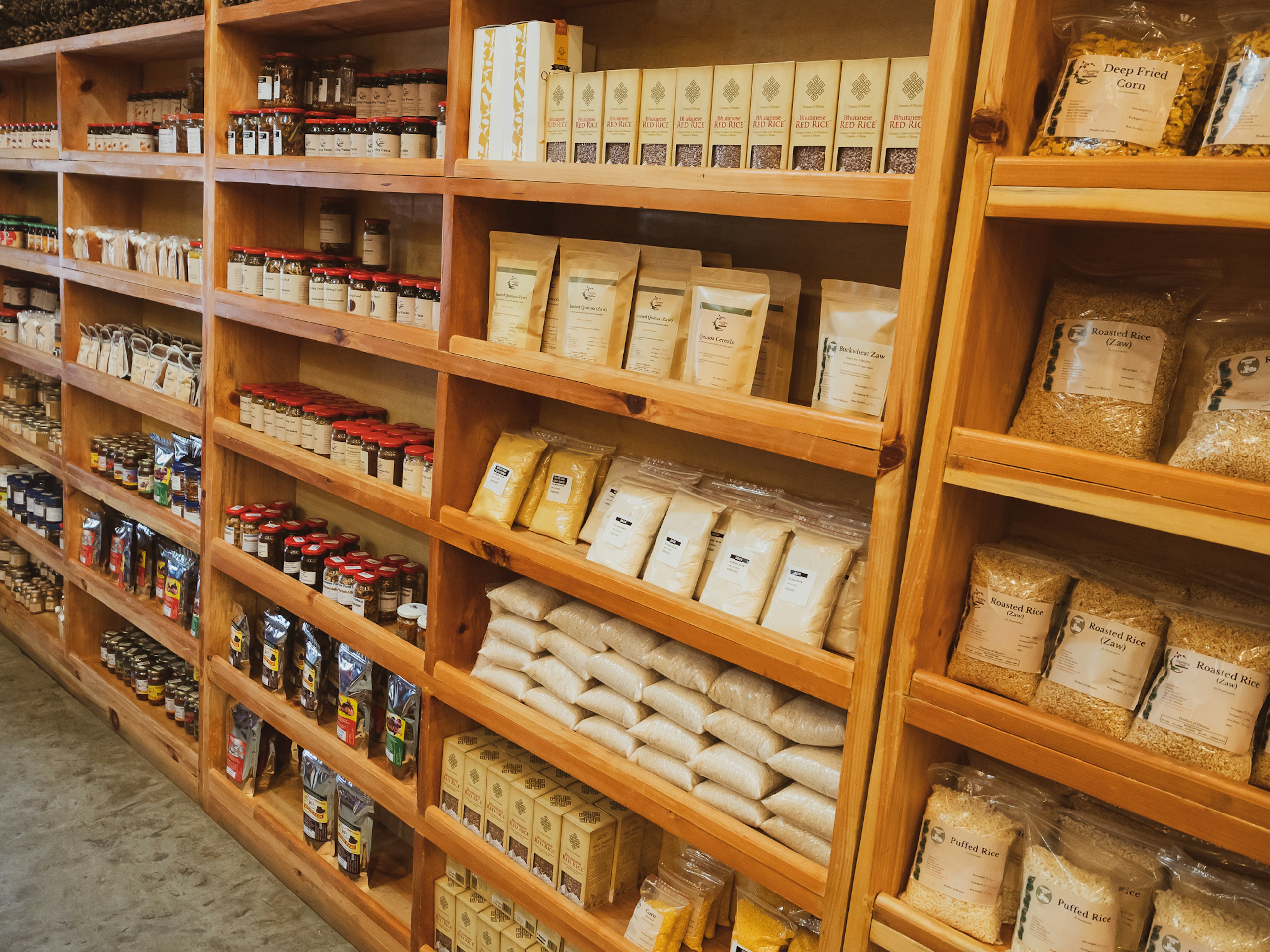 Wooden shelves filled with various spice and seasoning packages