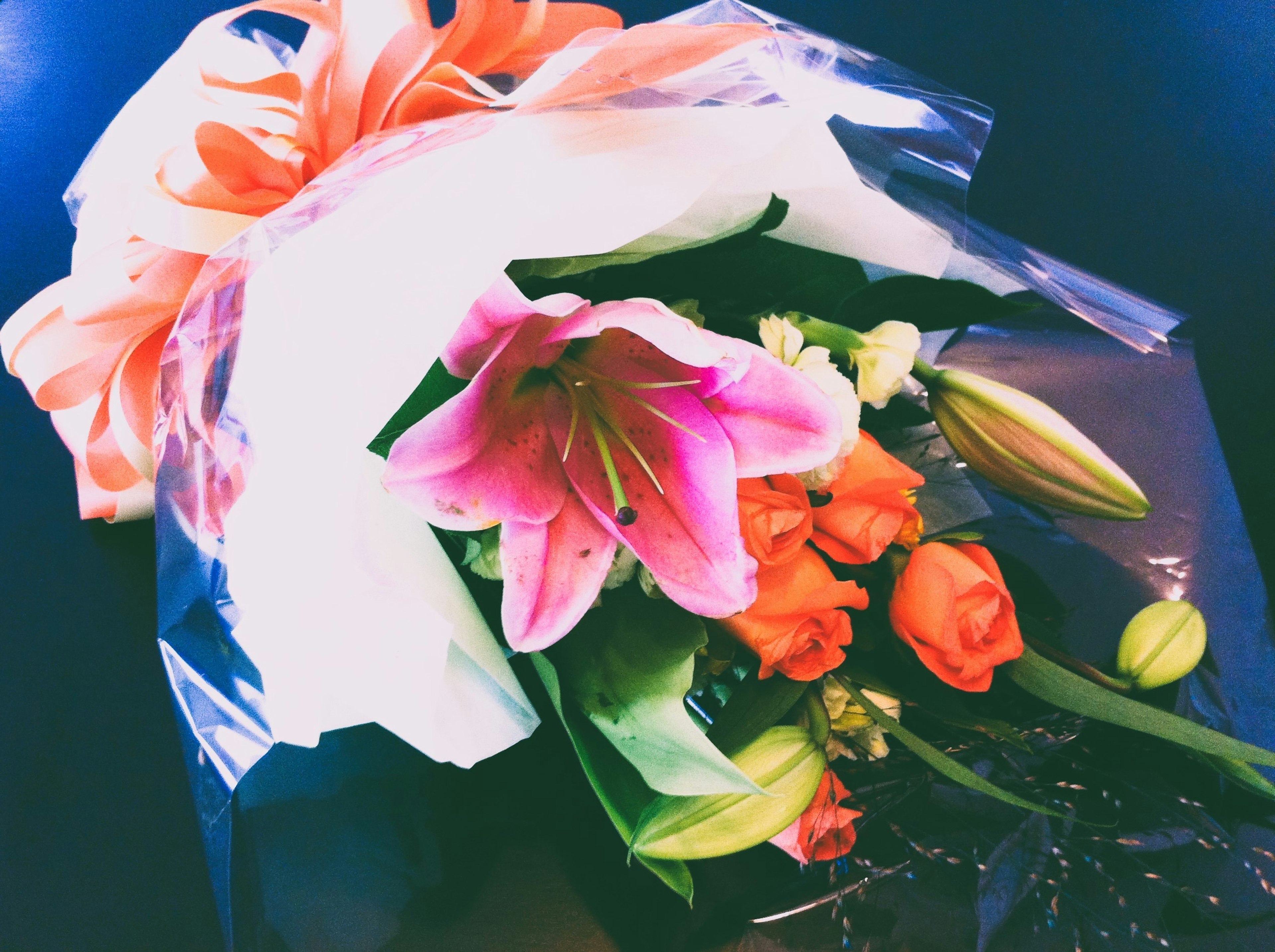 A beautiful bouquet featuring pink lilies and orange roses