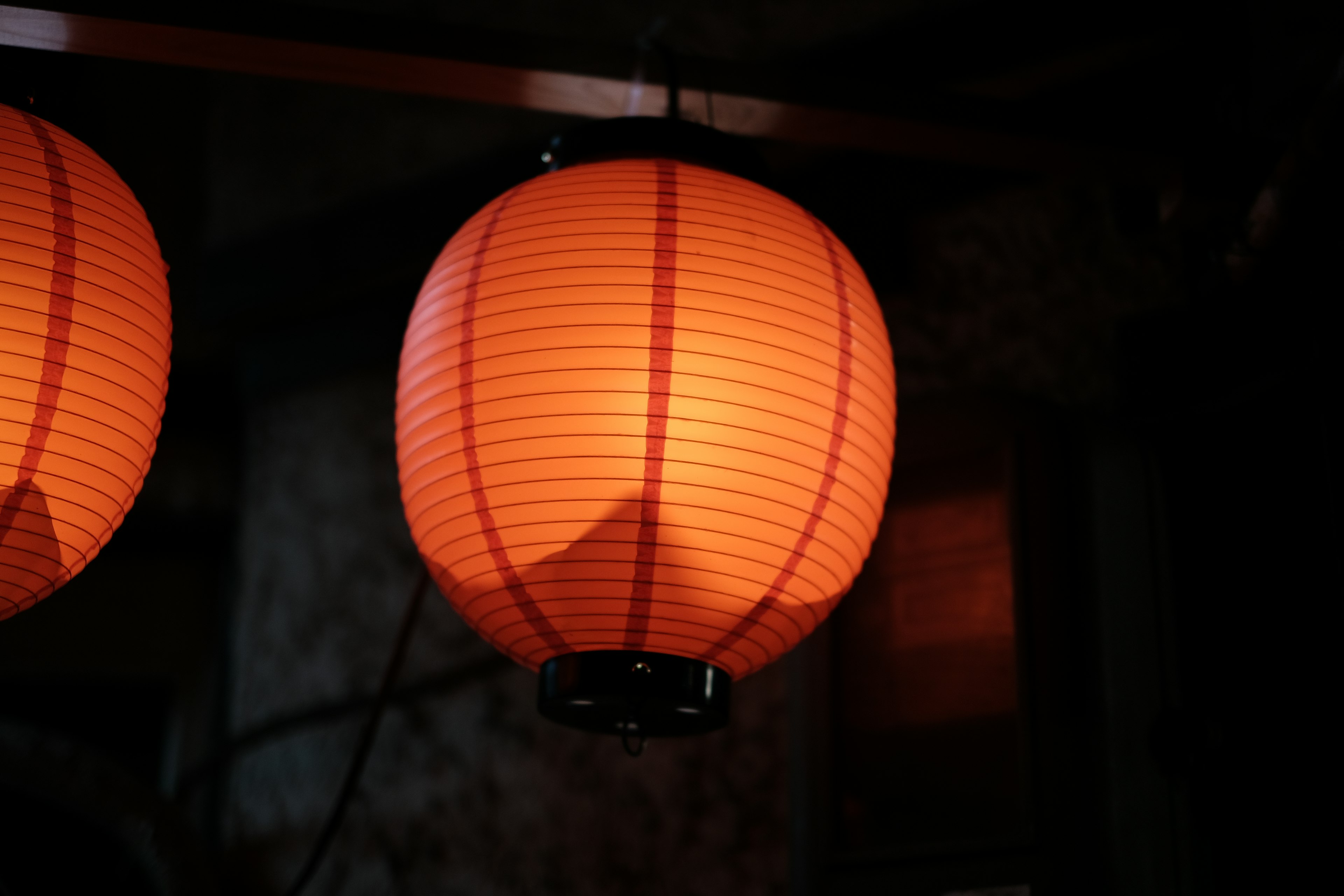 Orange paper lantern glowing softly against a dark background