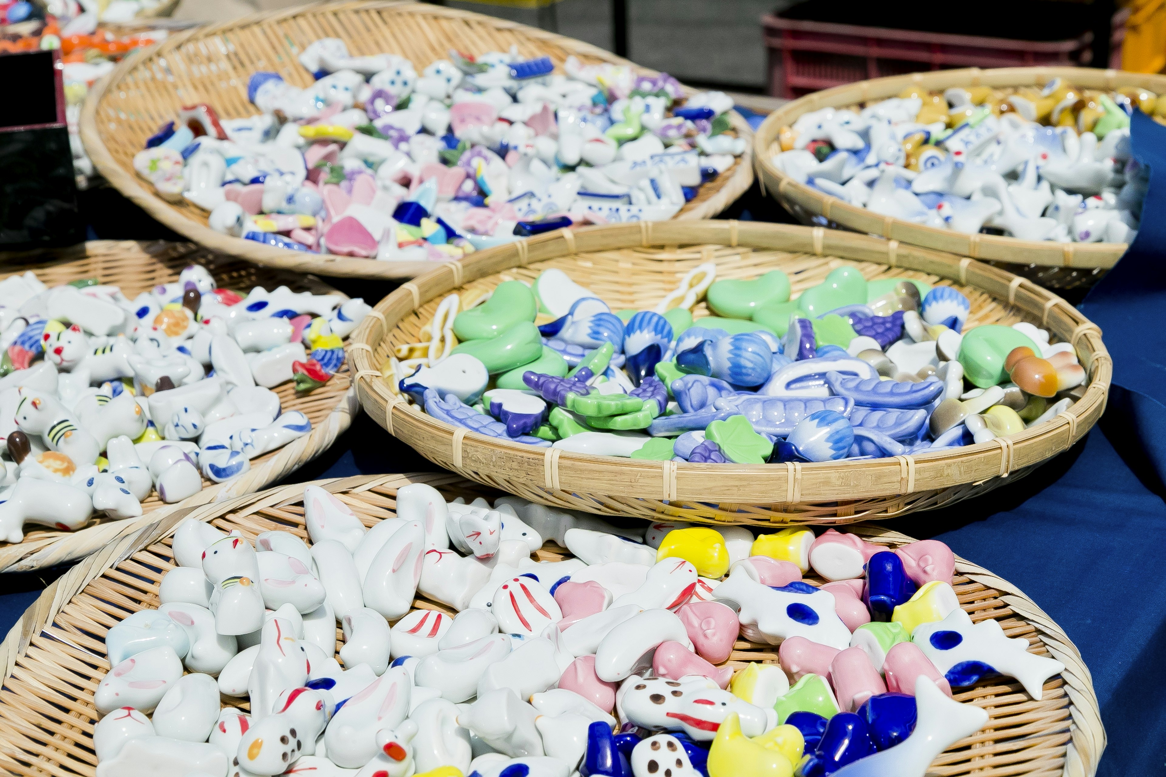 Colorful ceramic decorations arranged in several baskets