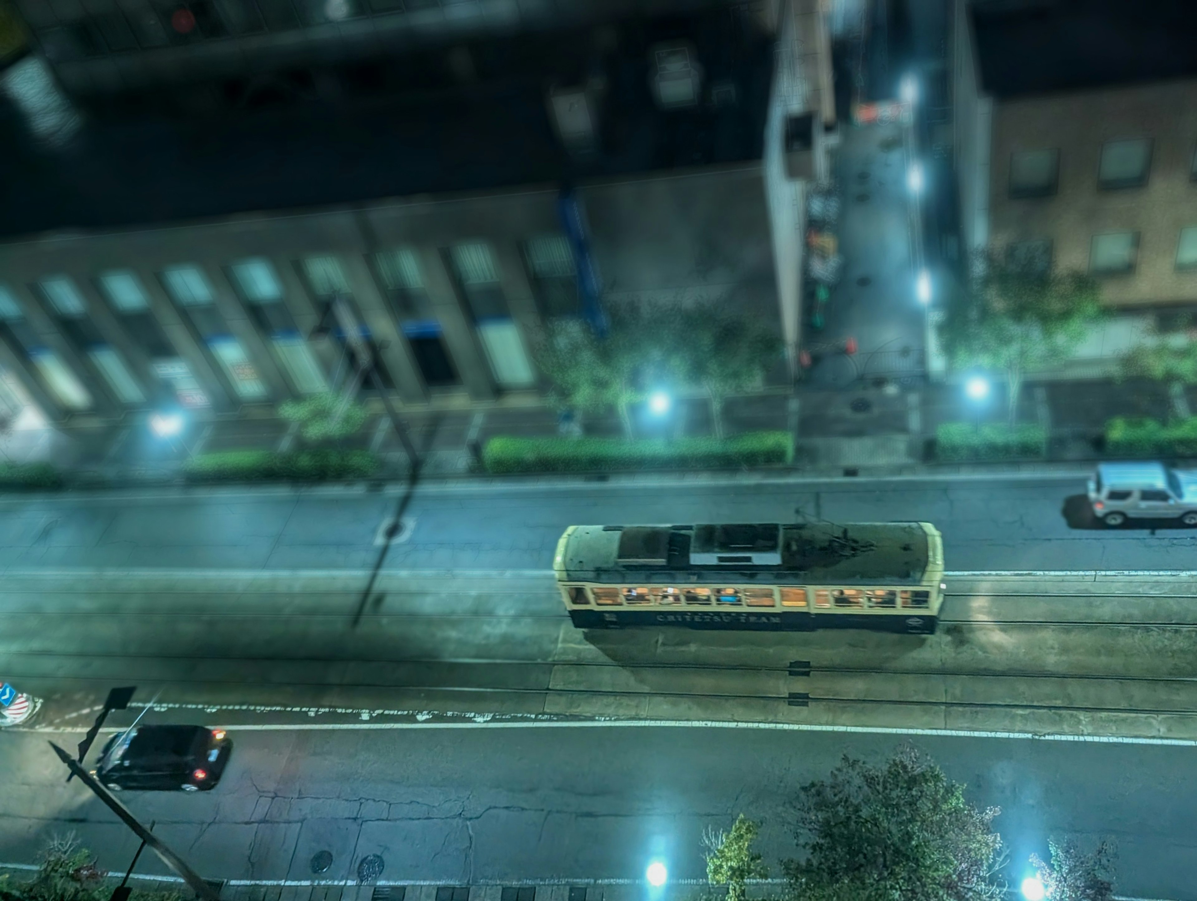 Aerial view of a tram on a city street at night