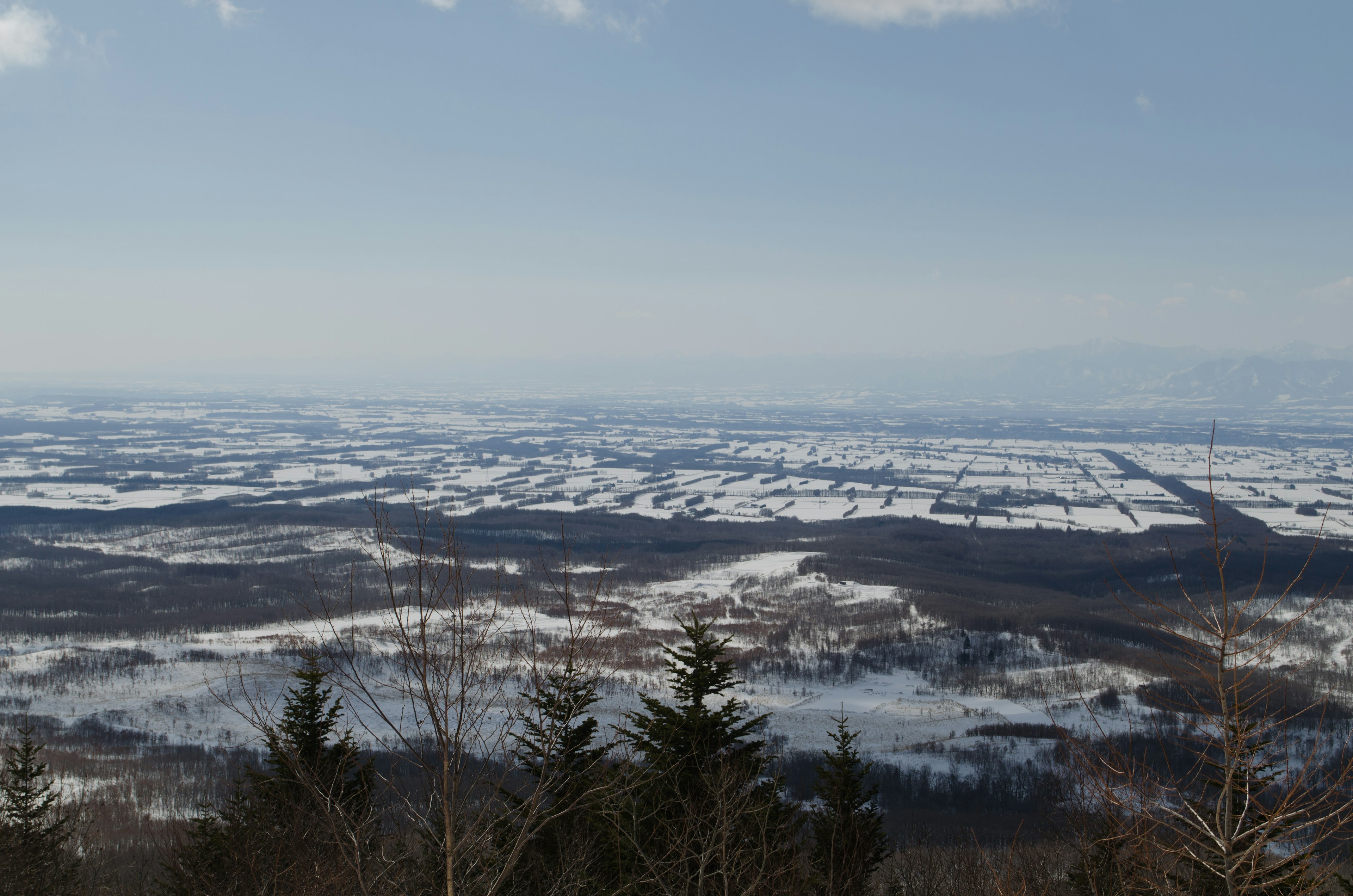 Vast snow-covered landscape under a blue sky