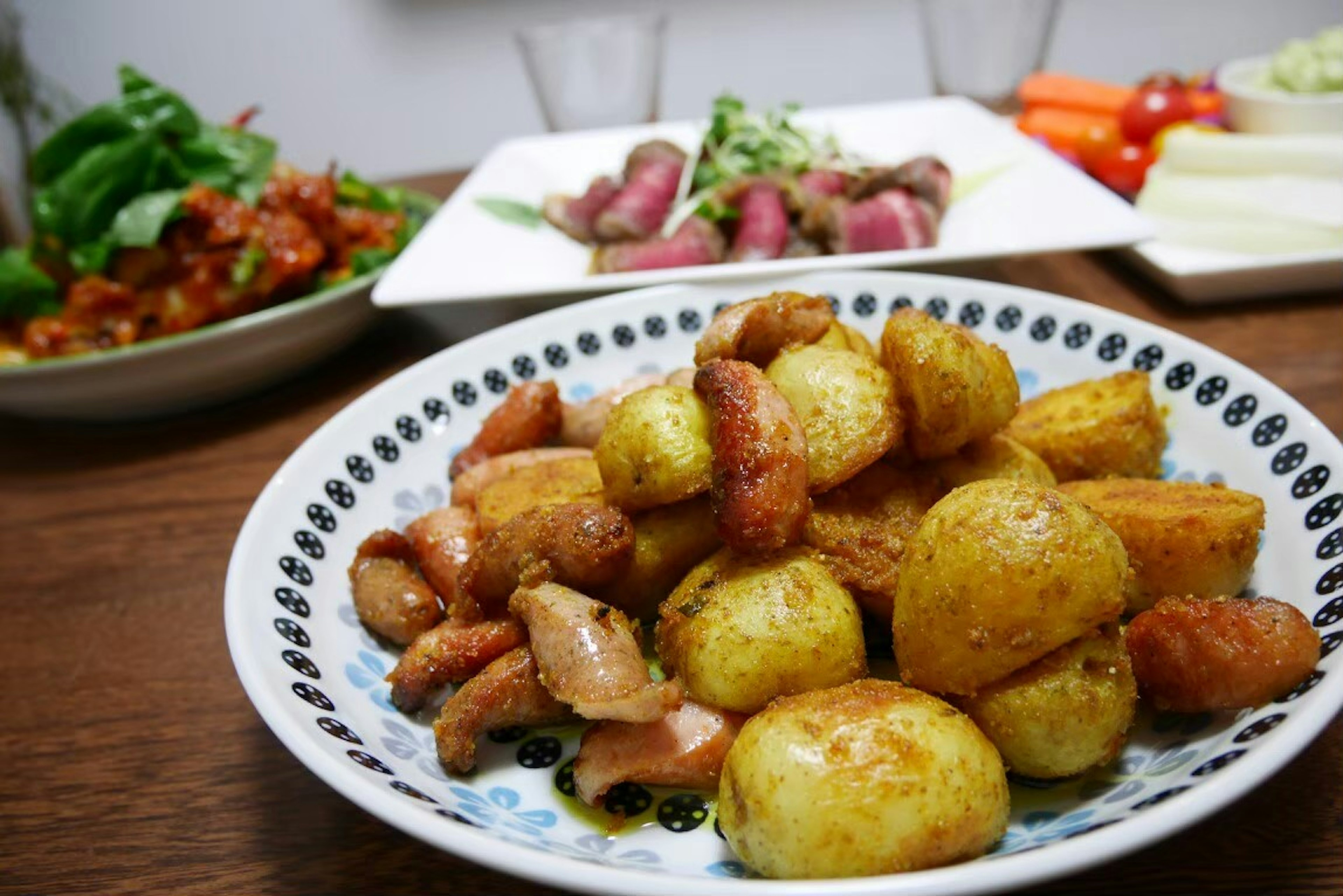 Plate of roasted potatoes and chicken served with vegetables