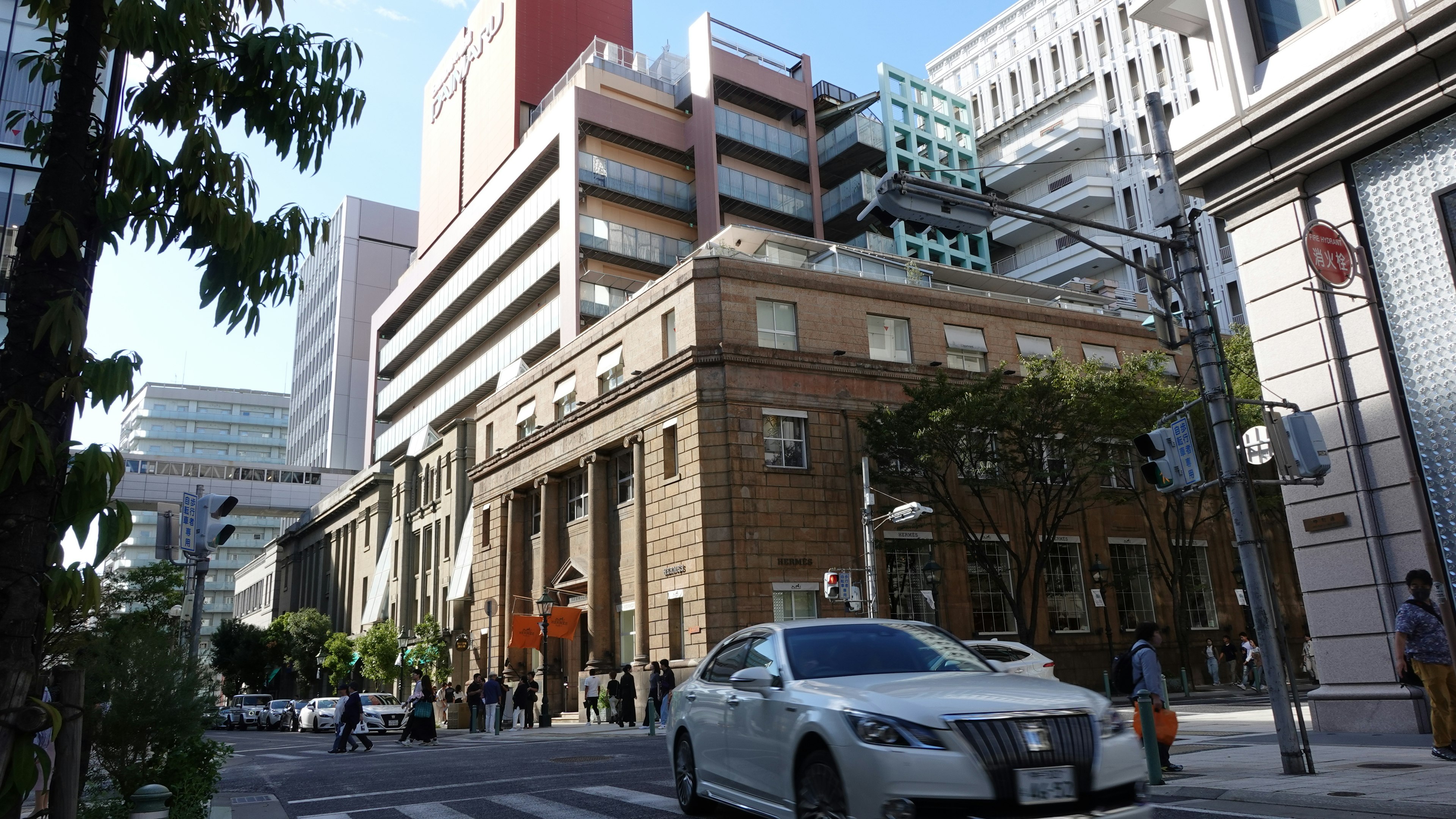 Modern buildings alongside a historic structure in an urban setting