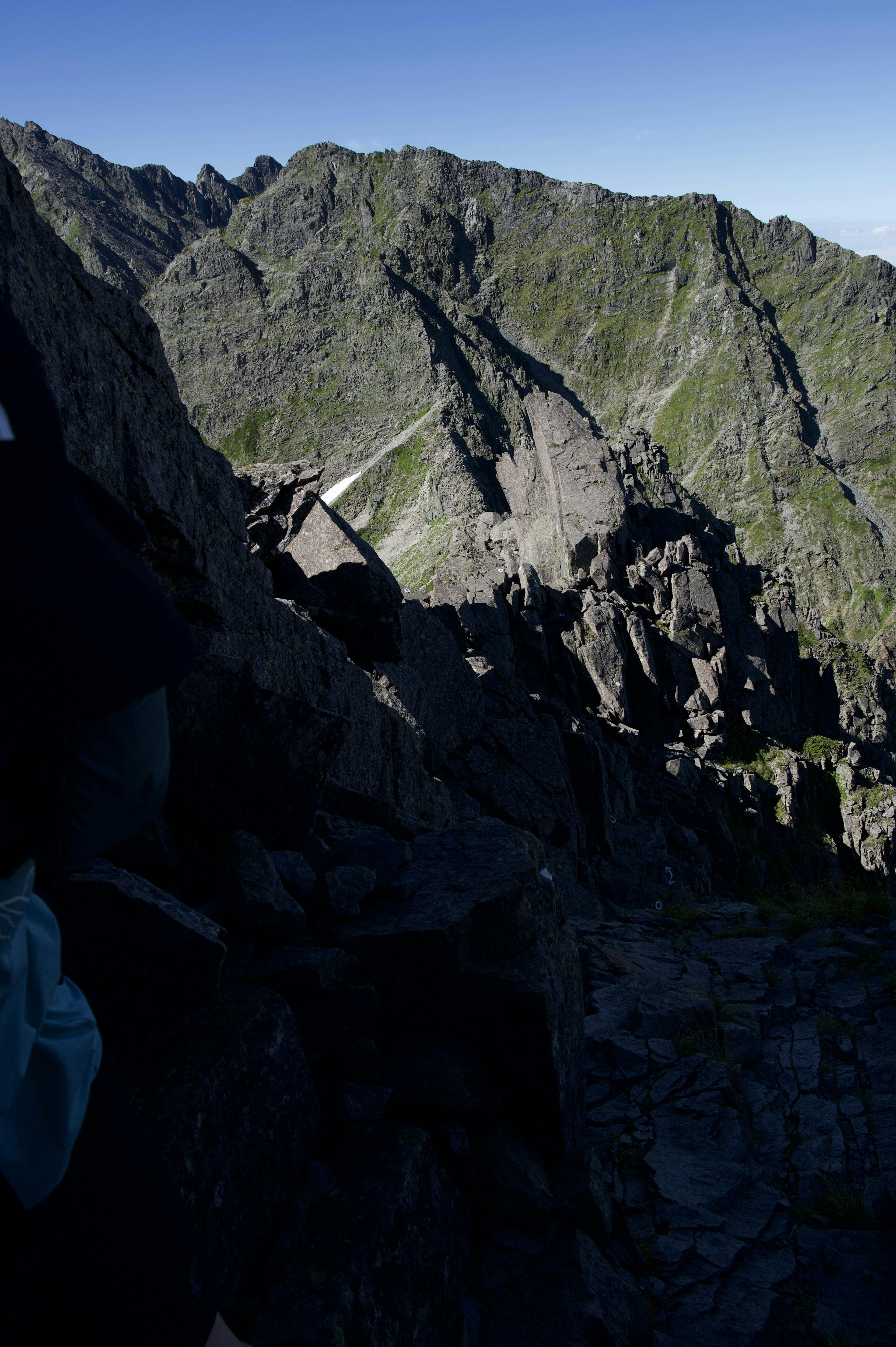 High-altitude view featuring mountain ridges and rocky terrain