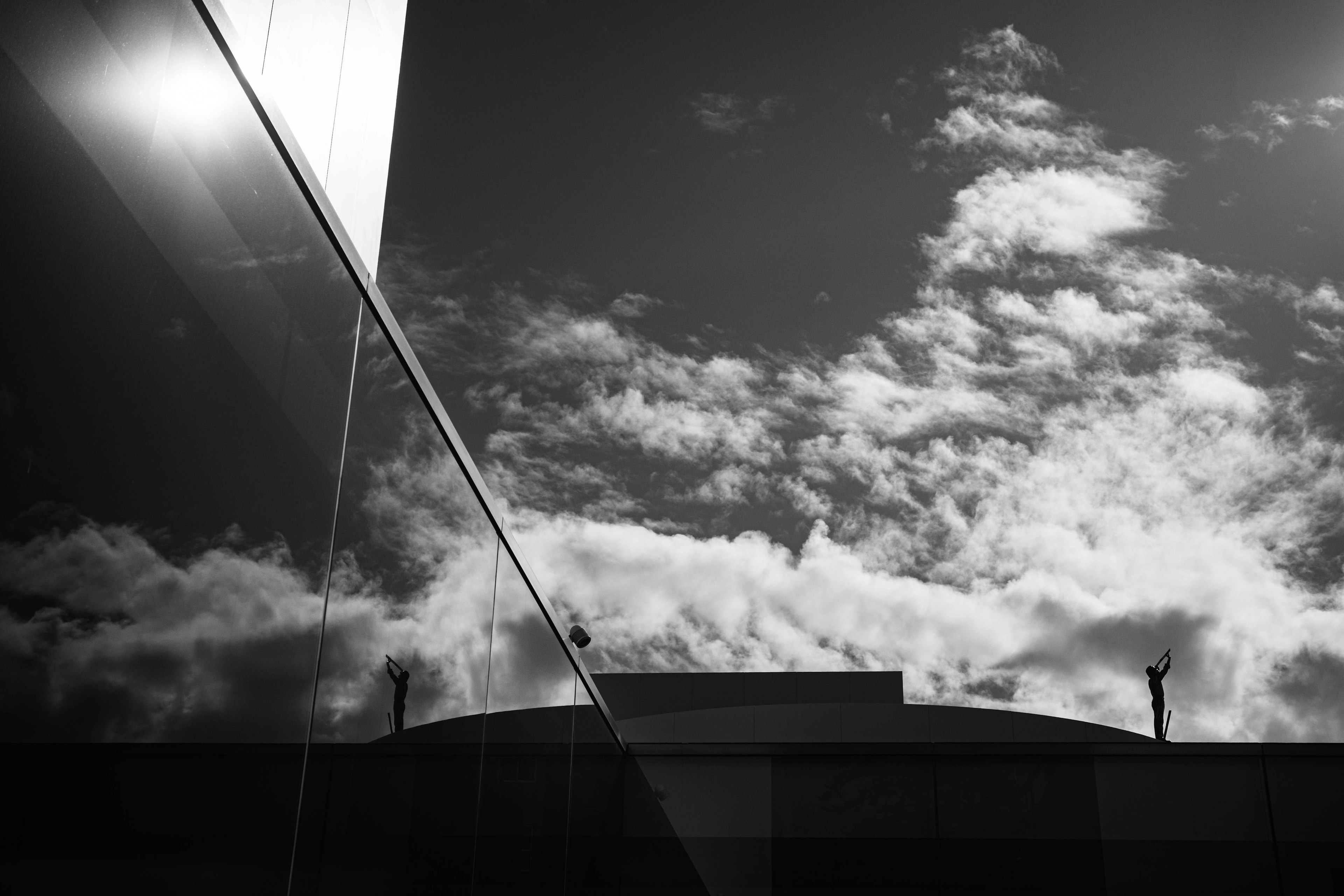 Black and white contrast of building reflection and clouds