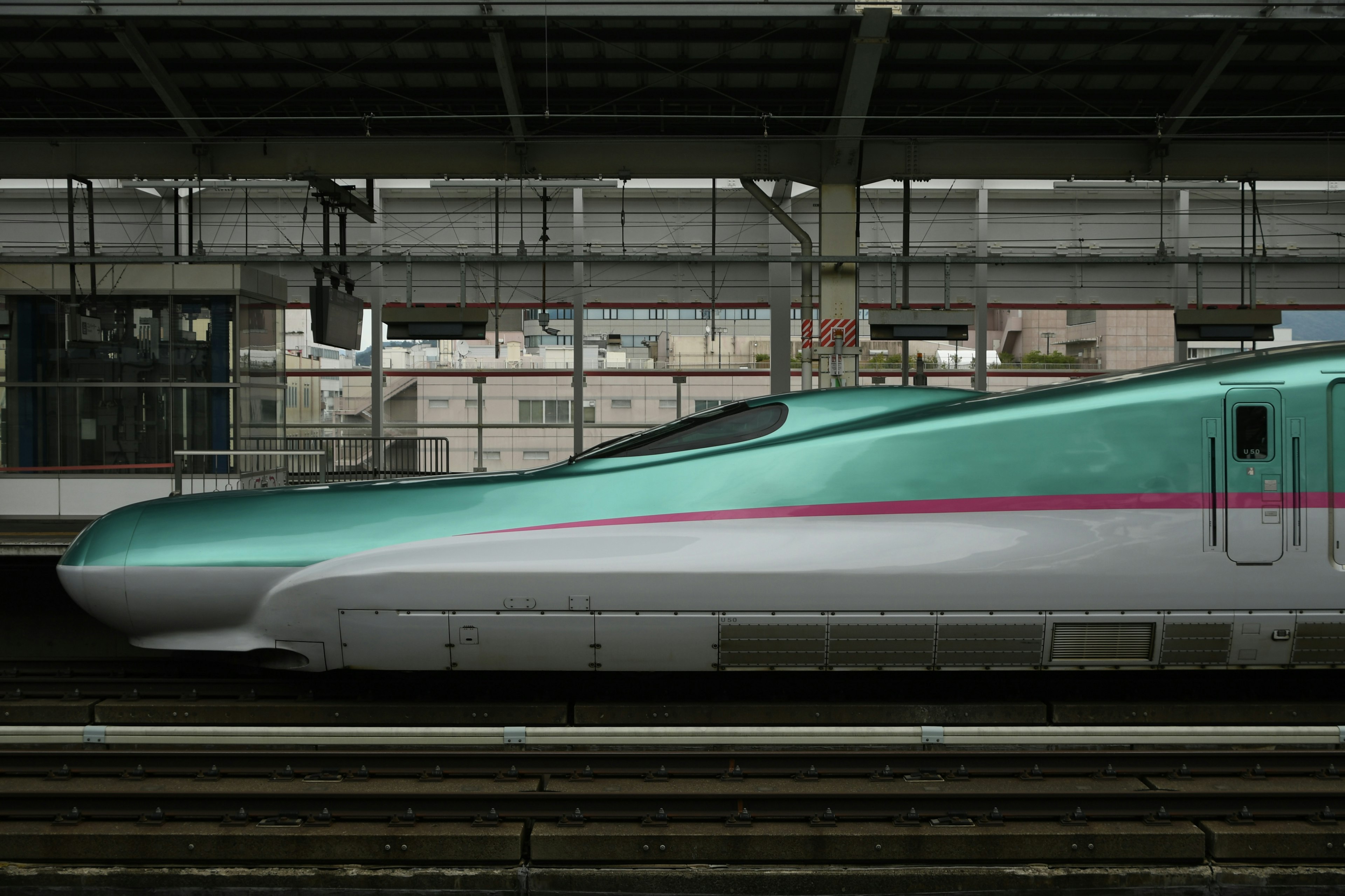 Two Shinkansen trains side by side at a train station