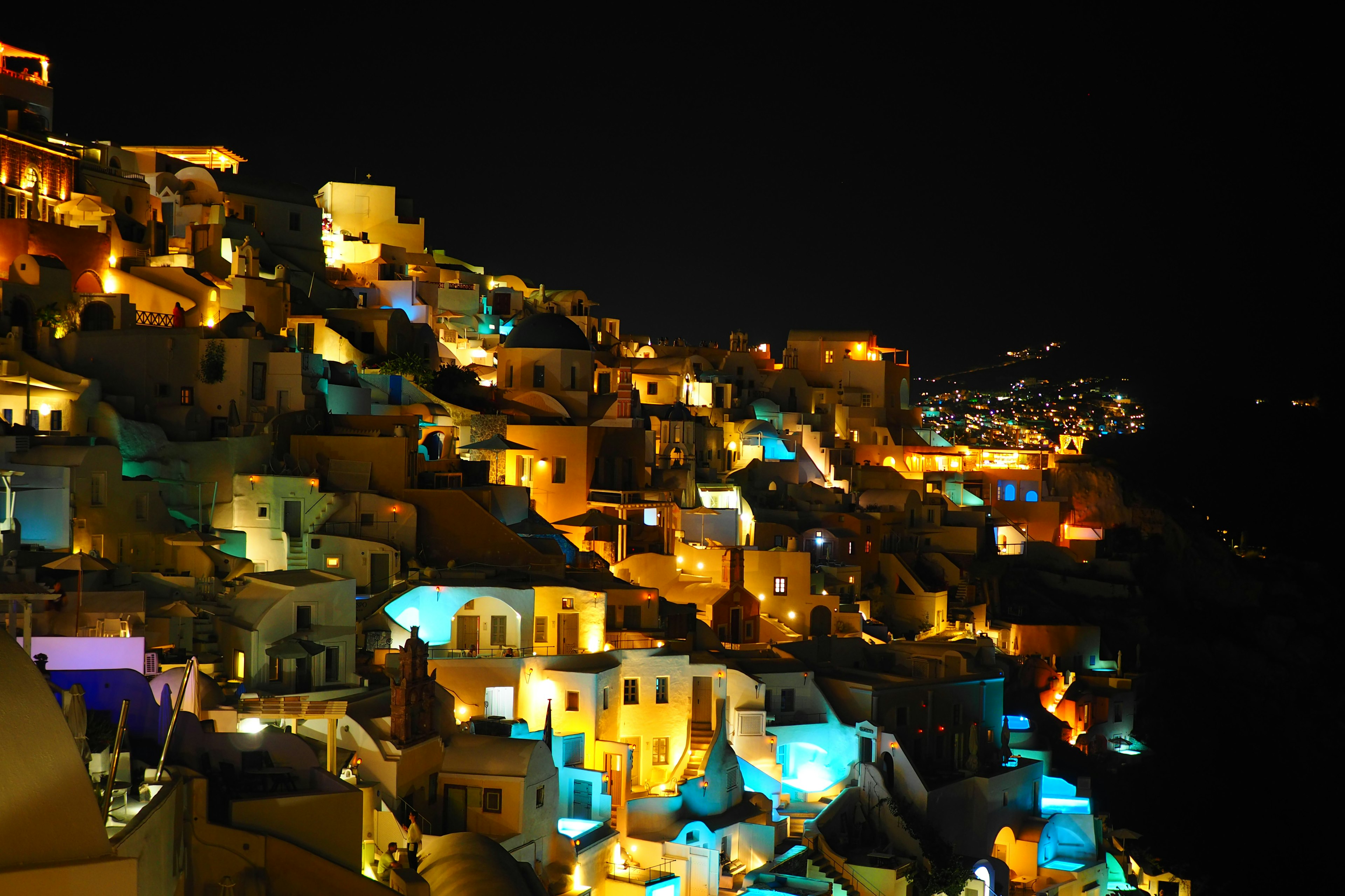 Stunning illuminated houses on the hills of Santorini at night