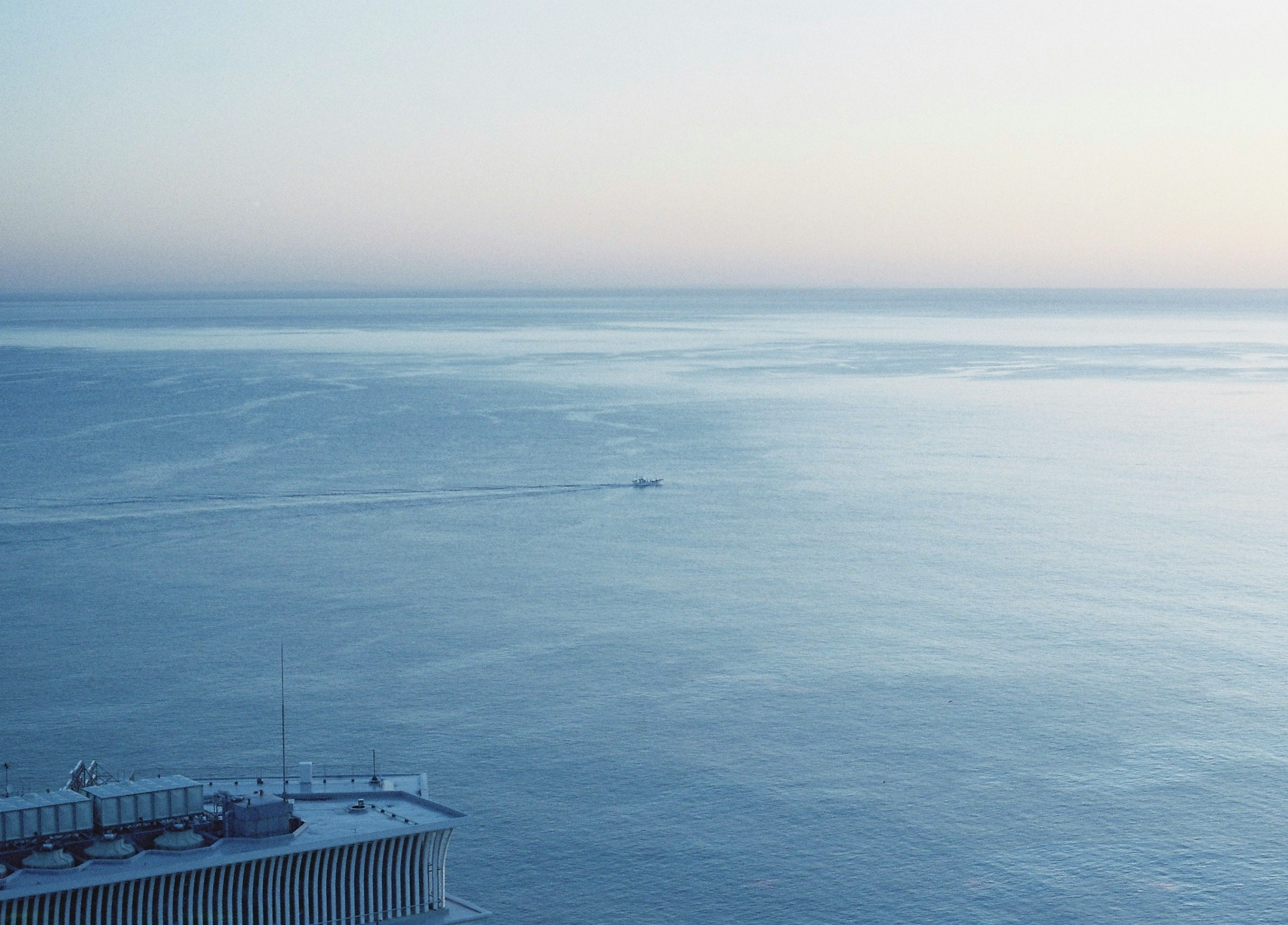 Serene ocean view with a small boat in the distance