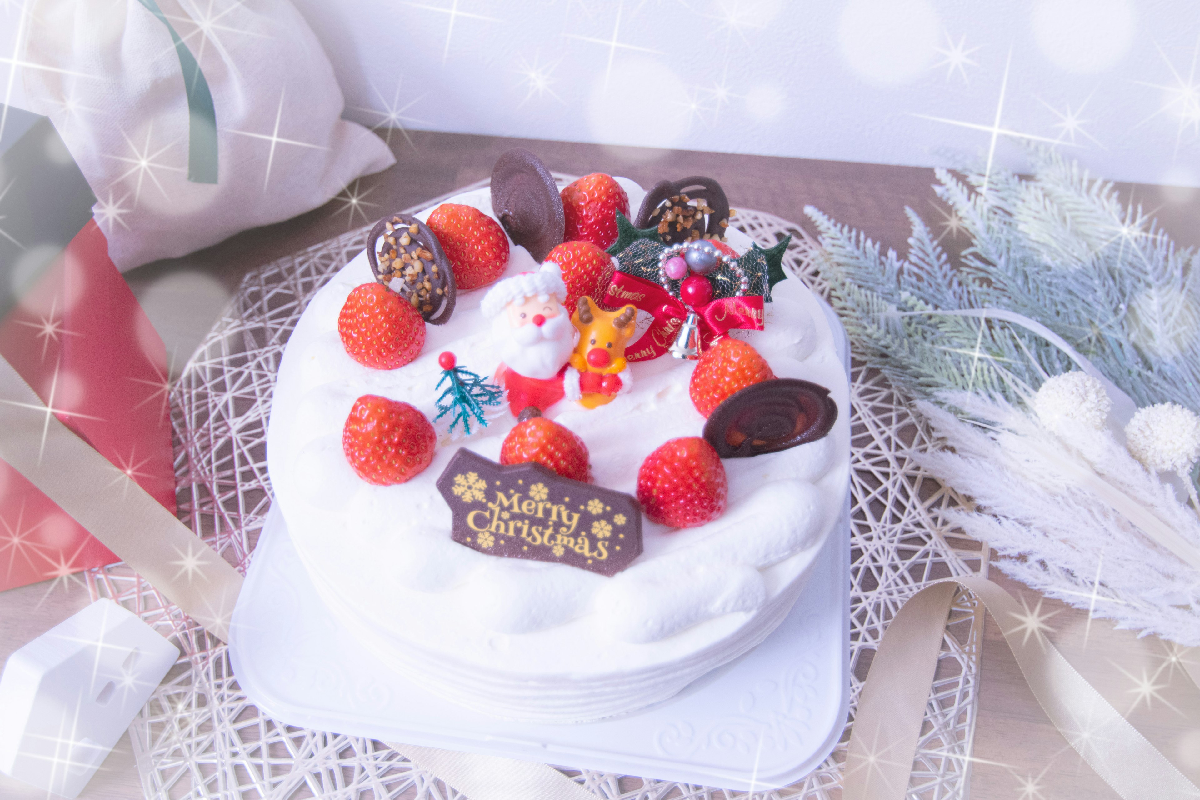 Christmas cake decorated with Santa figurines and strawberries