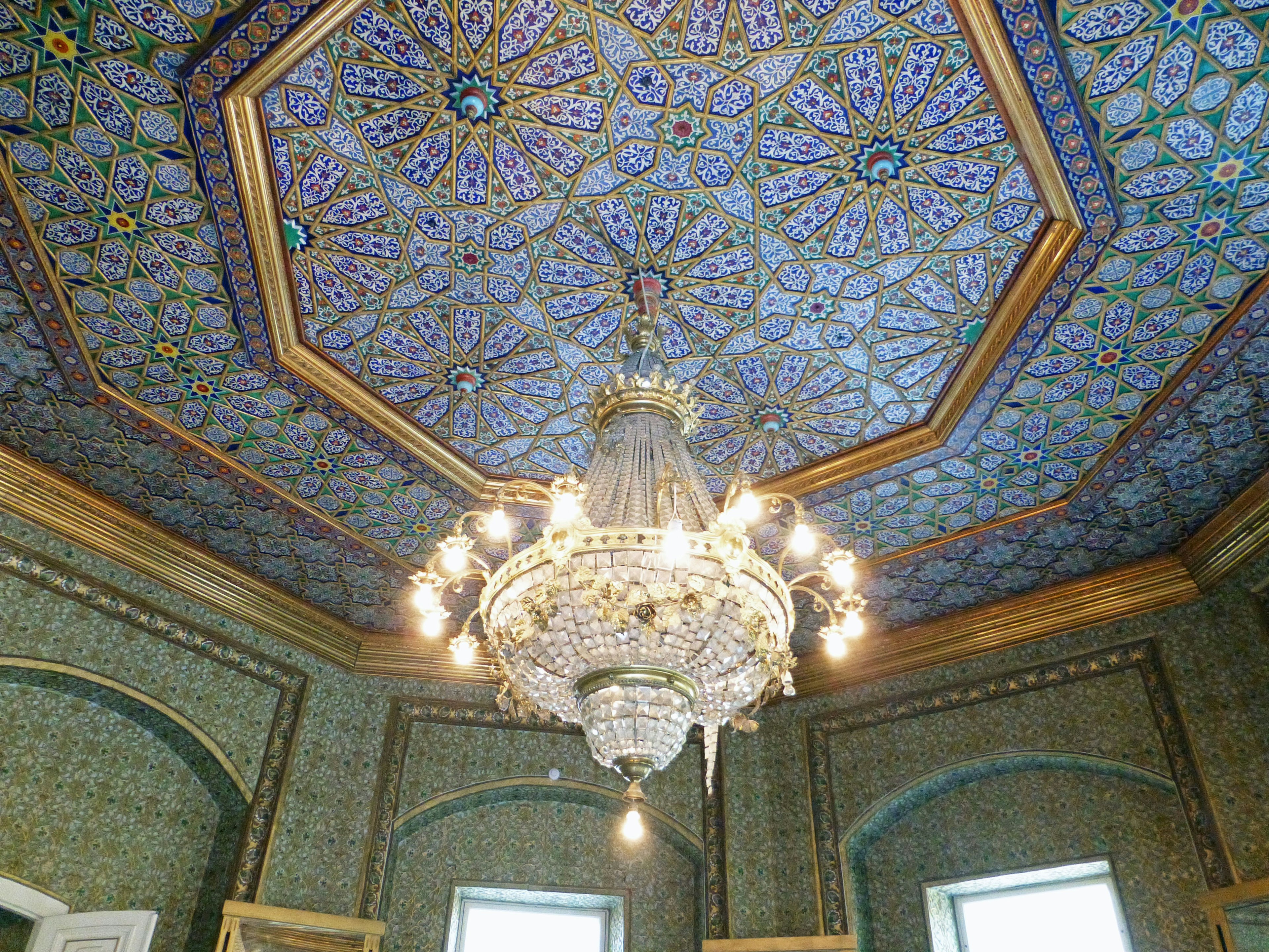 Room featuring an ornate chandelier and a beautifully decorated ceiling