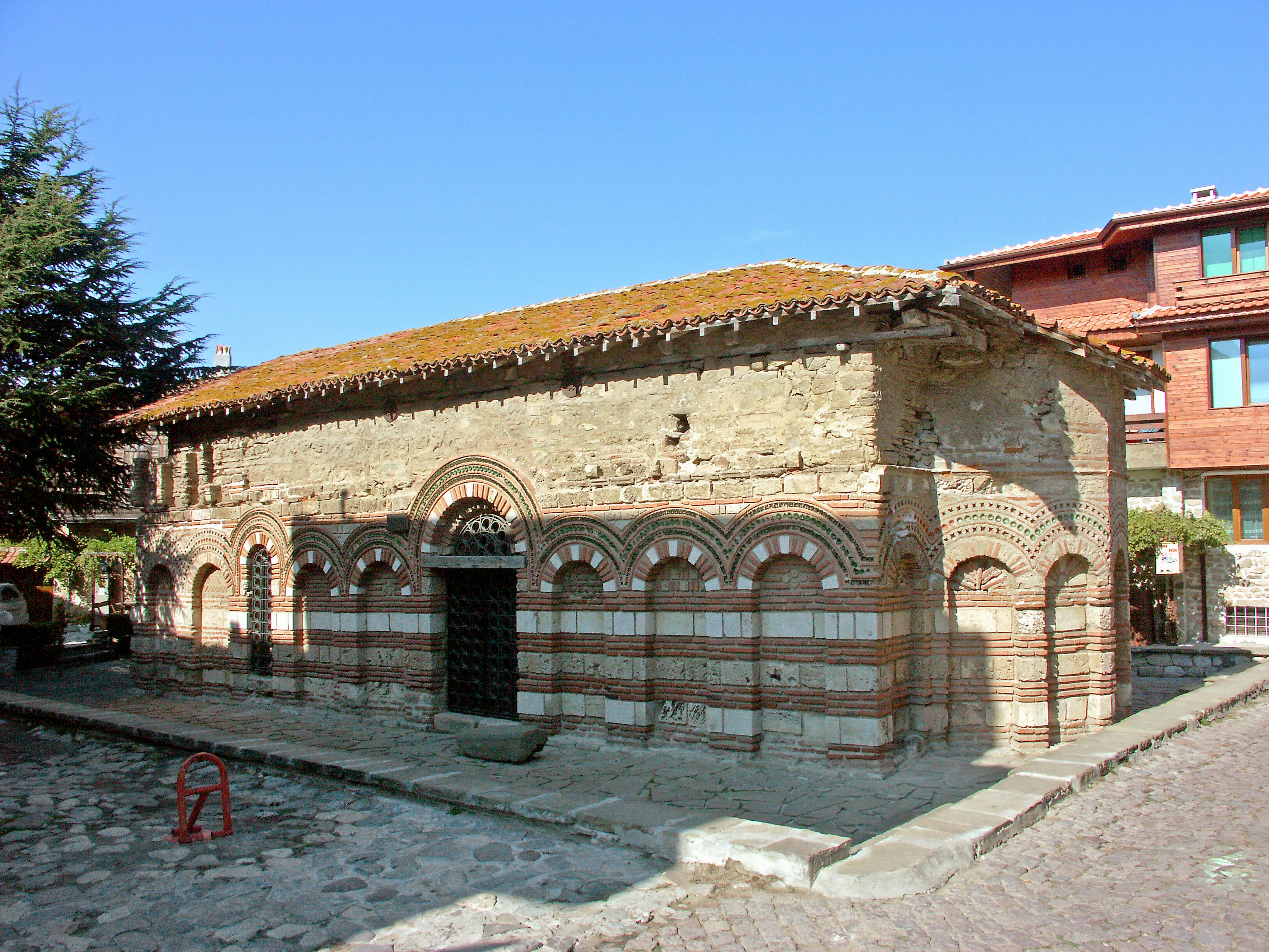 Historic stone church under a clear blue sky