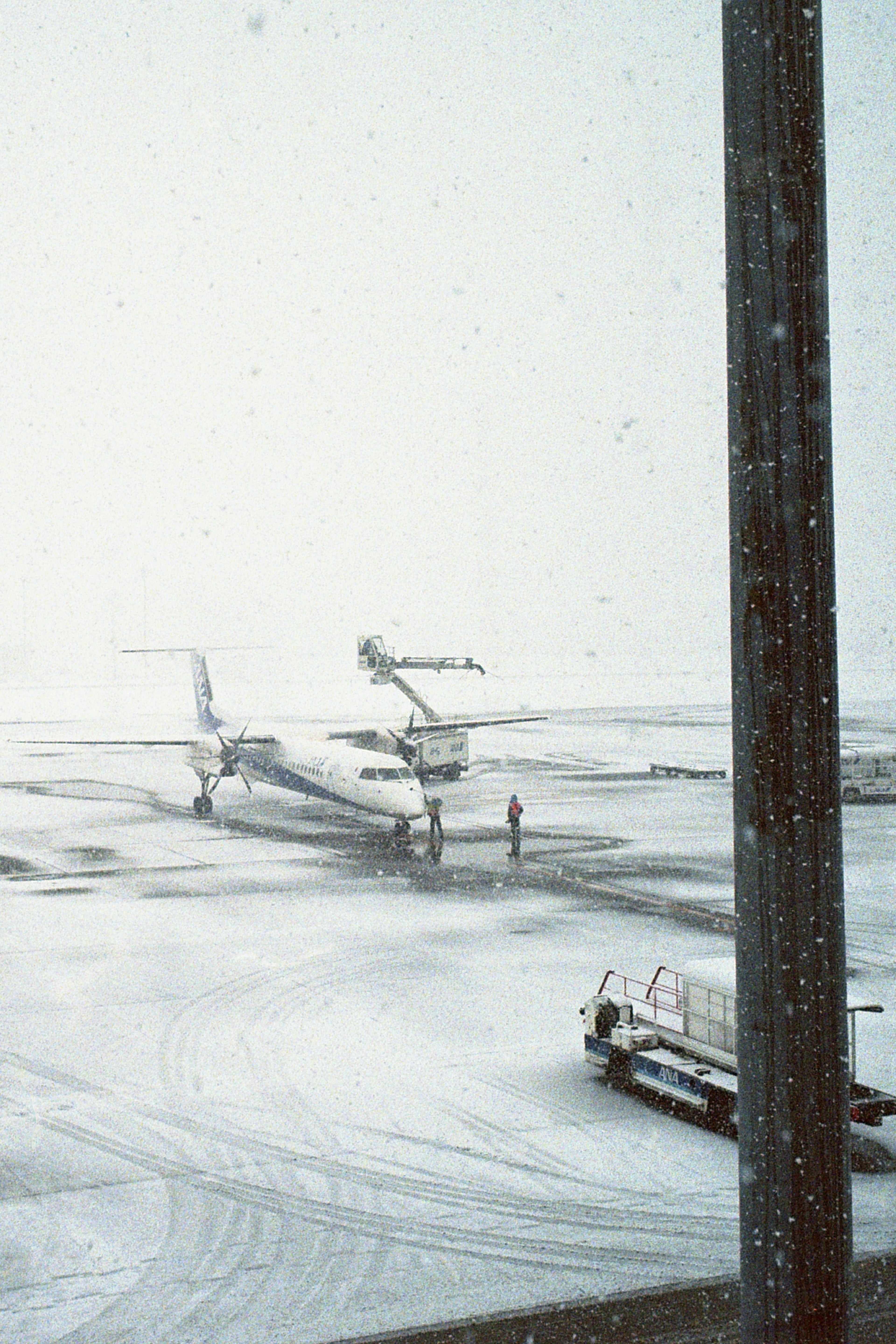 Airplane on a snowy runway with snow falling