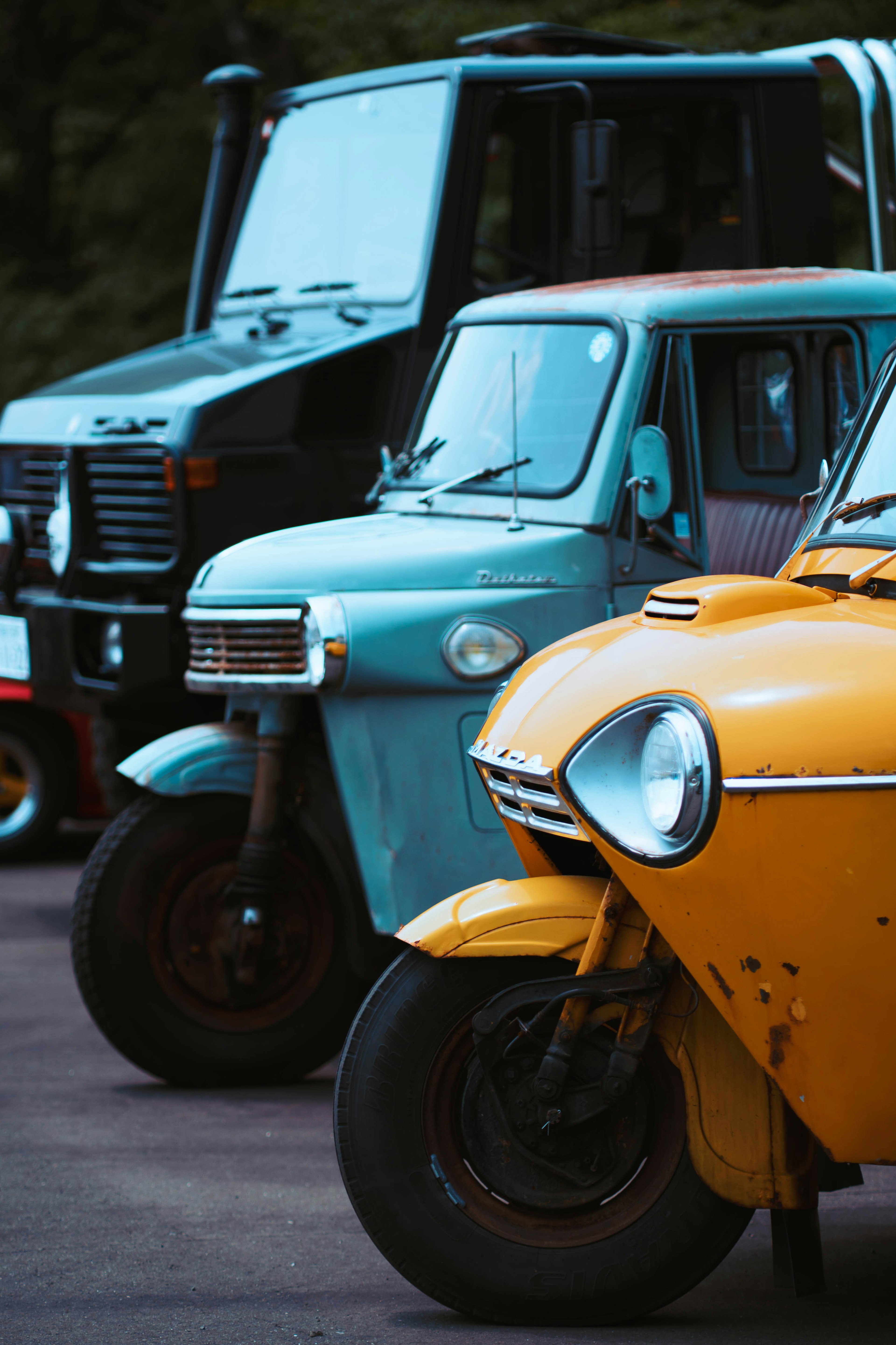 Three unique colorful vehicles lined up