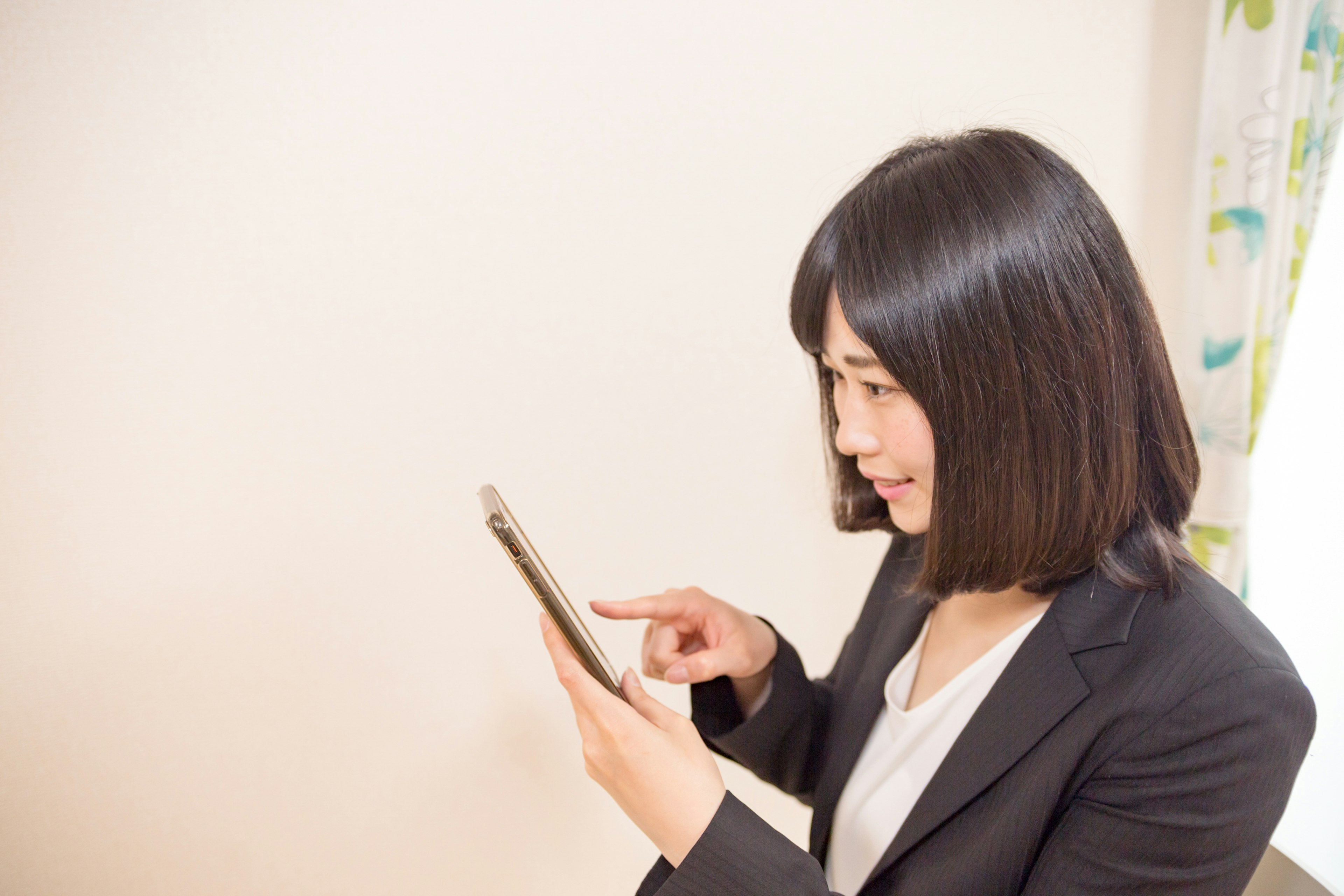 A woman interacting with a tablet in a business setting