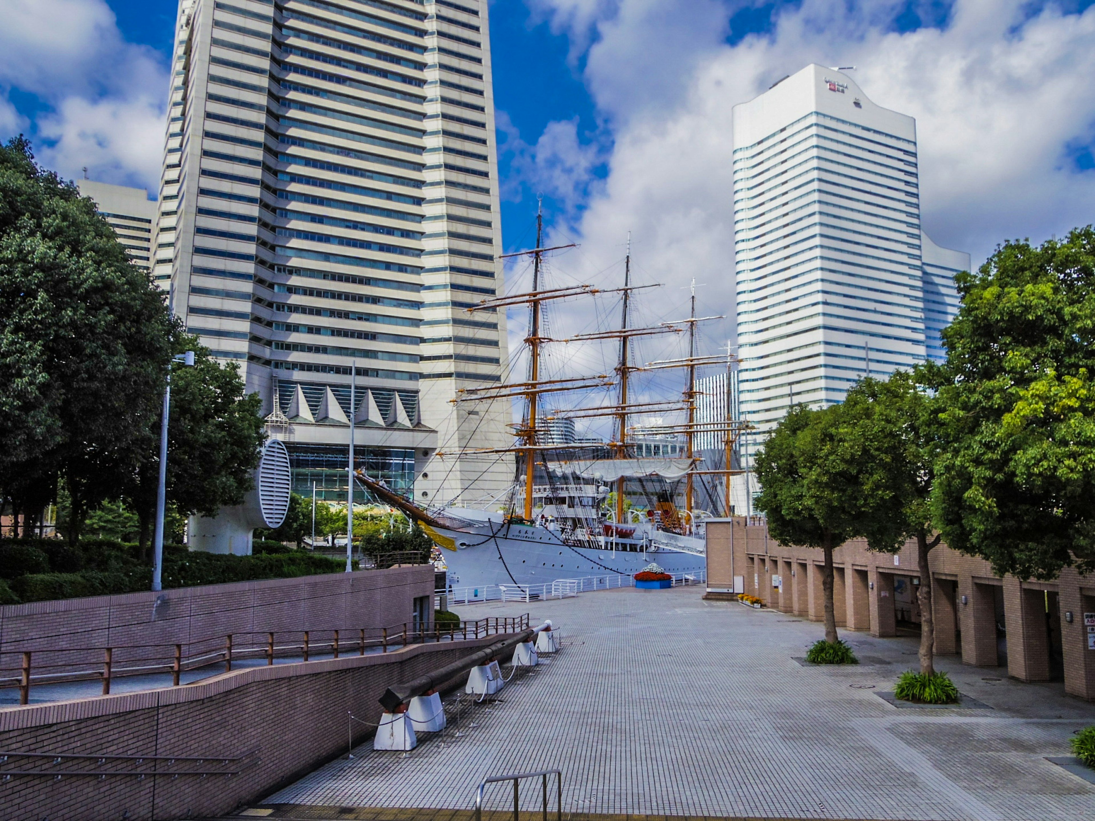 Urban landscape featuring skyscrapers and a sailing ship