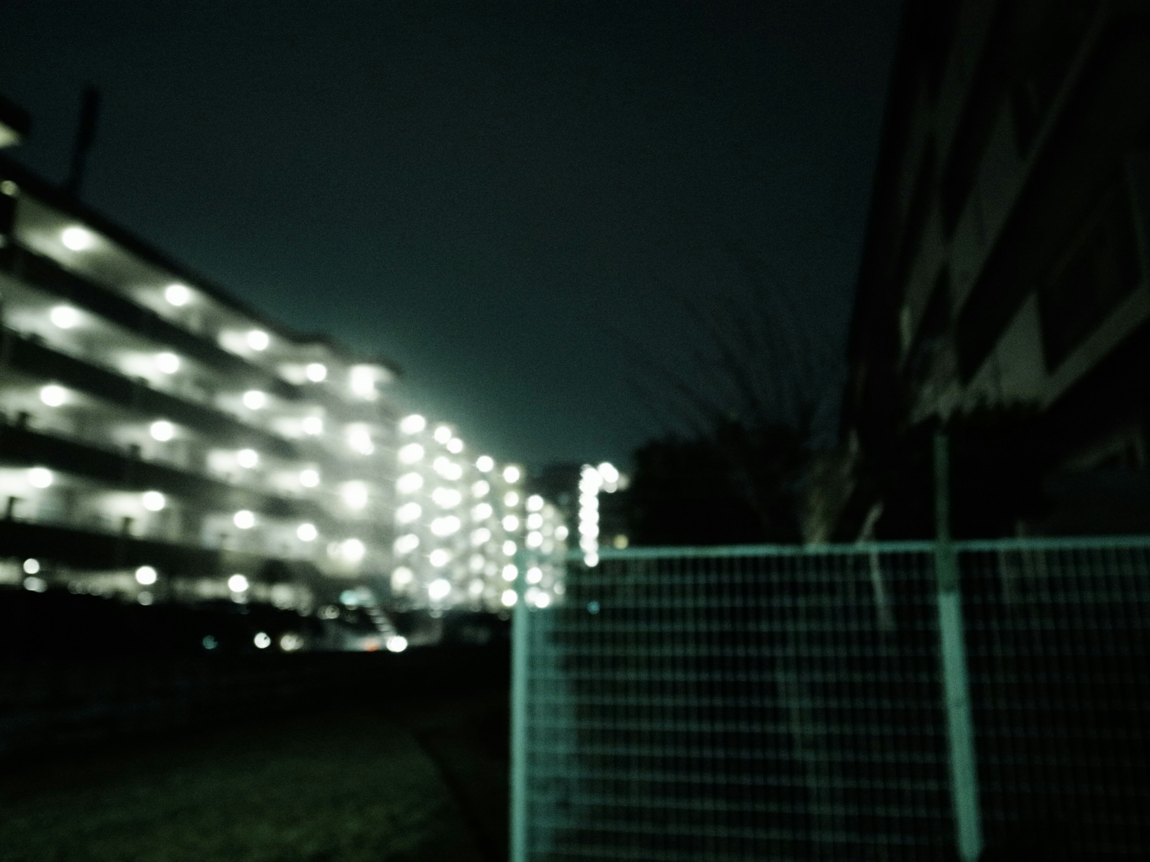 Blurred night view of a residential area illuminated apartment buildings