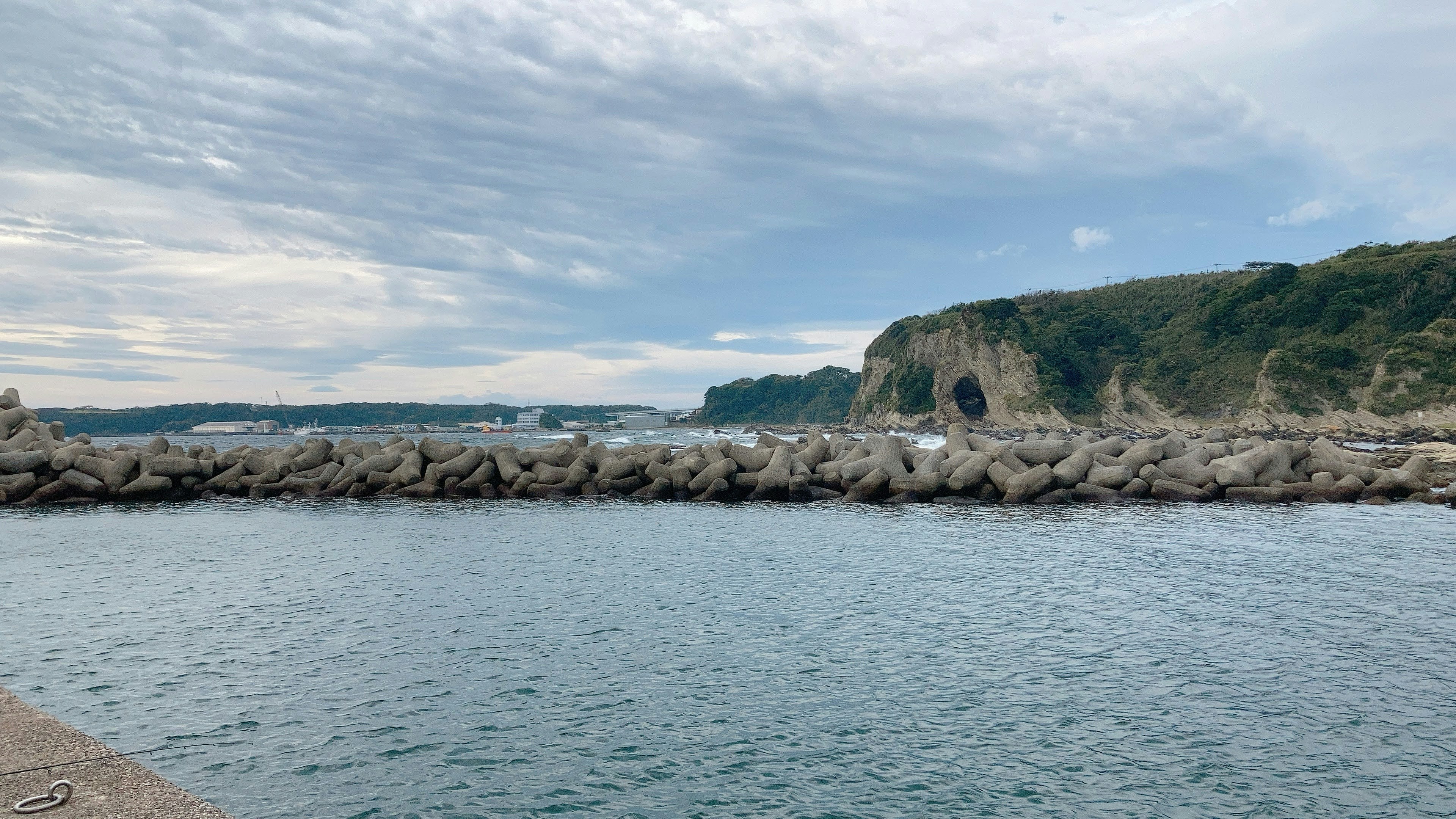 Coastal view with rocks and cloudy sky