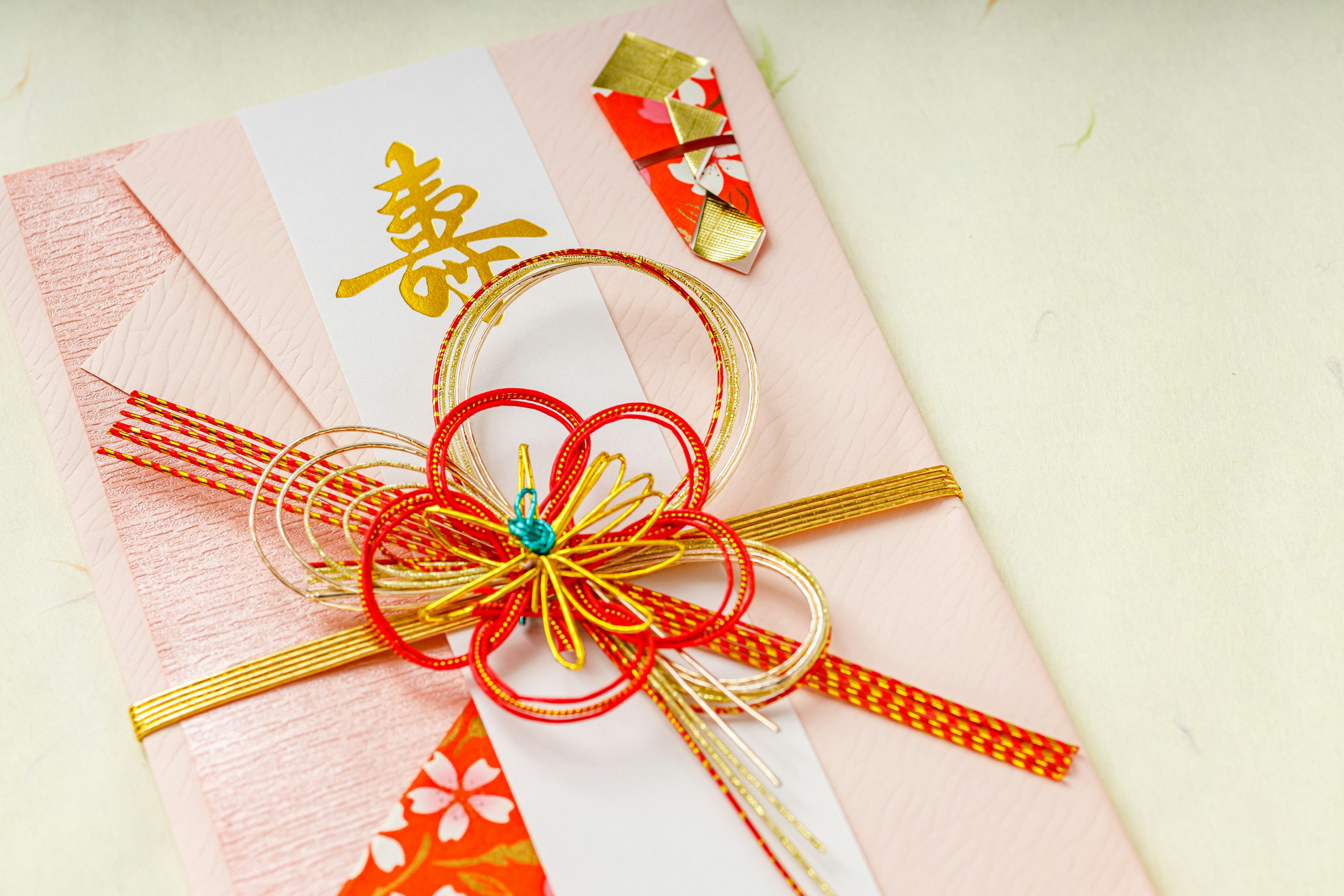 A beautiful Japanese-style envelope with vibrant decorative knots and gold accents