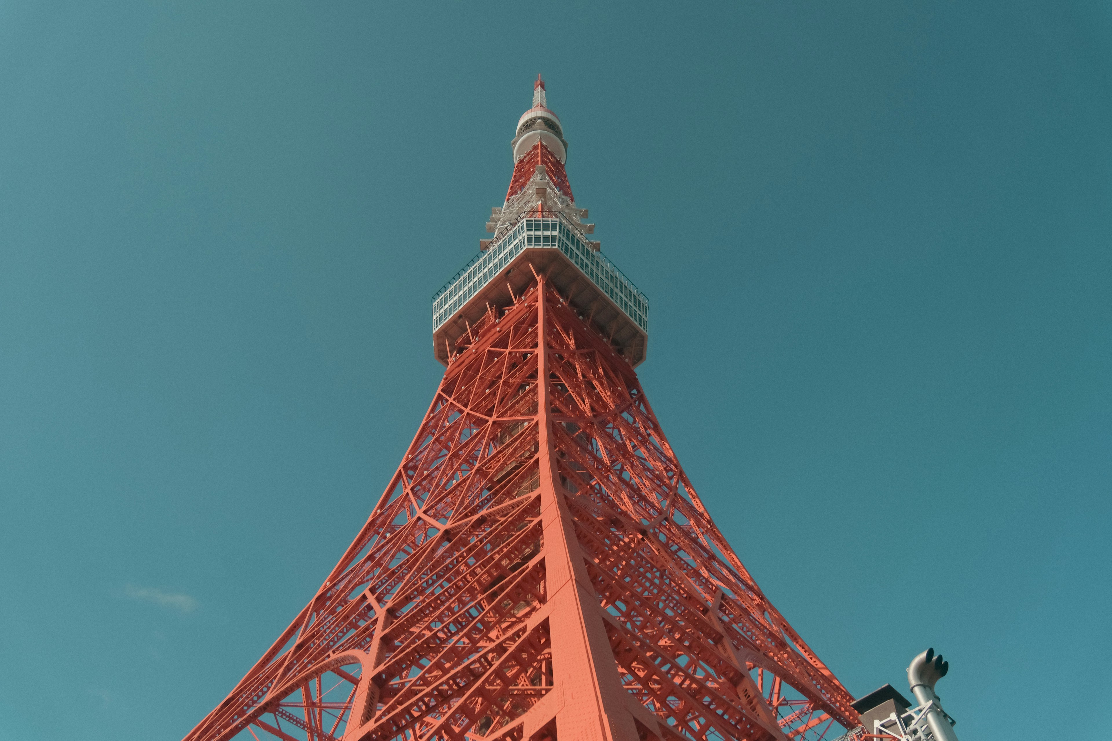 Tokyo Tower viewed from below against a blue sky