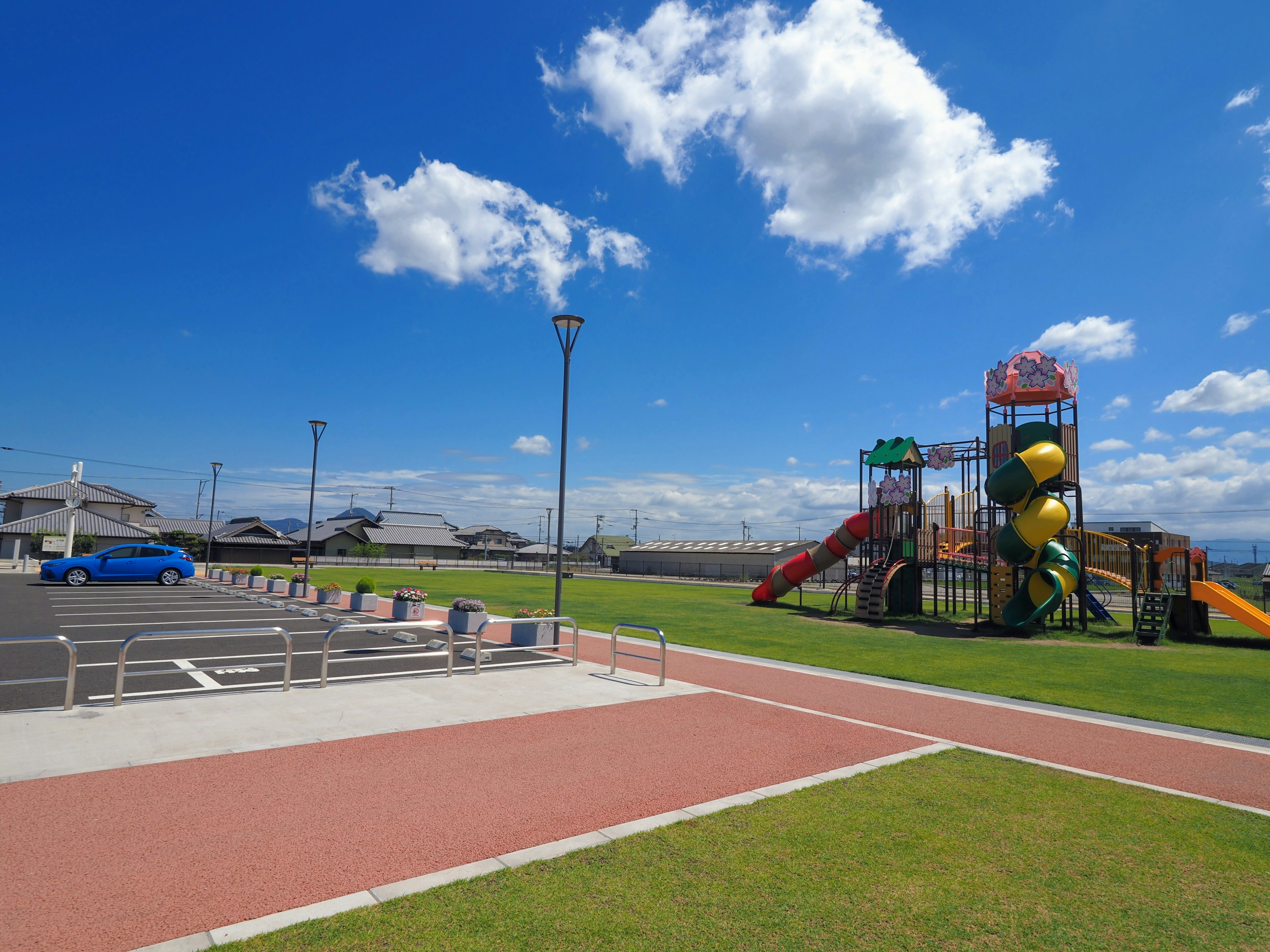 Playground with colorful slides under a bright blue sky