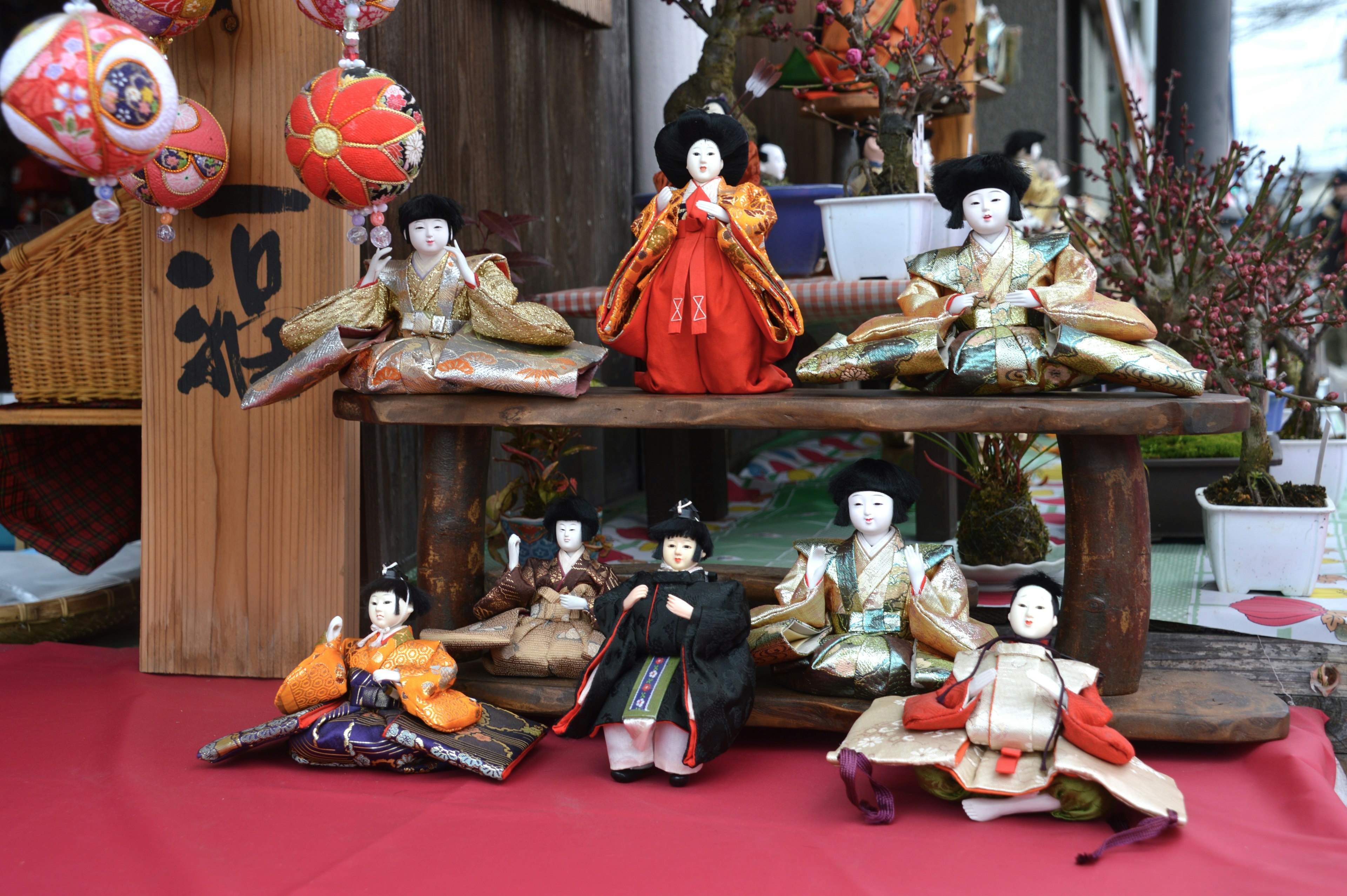 Traditional hina dolls displayed on a shelf with colorful garments