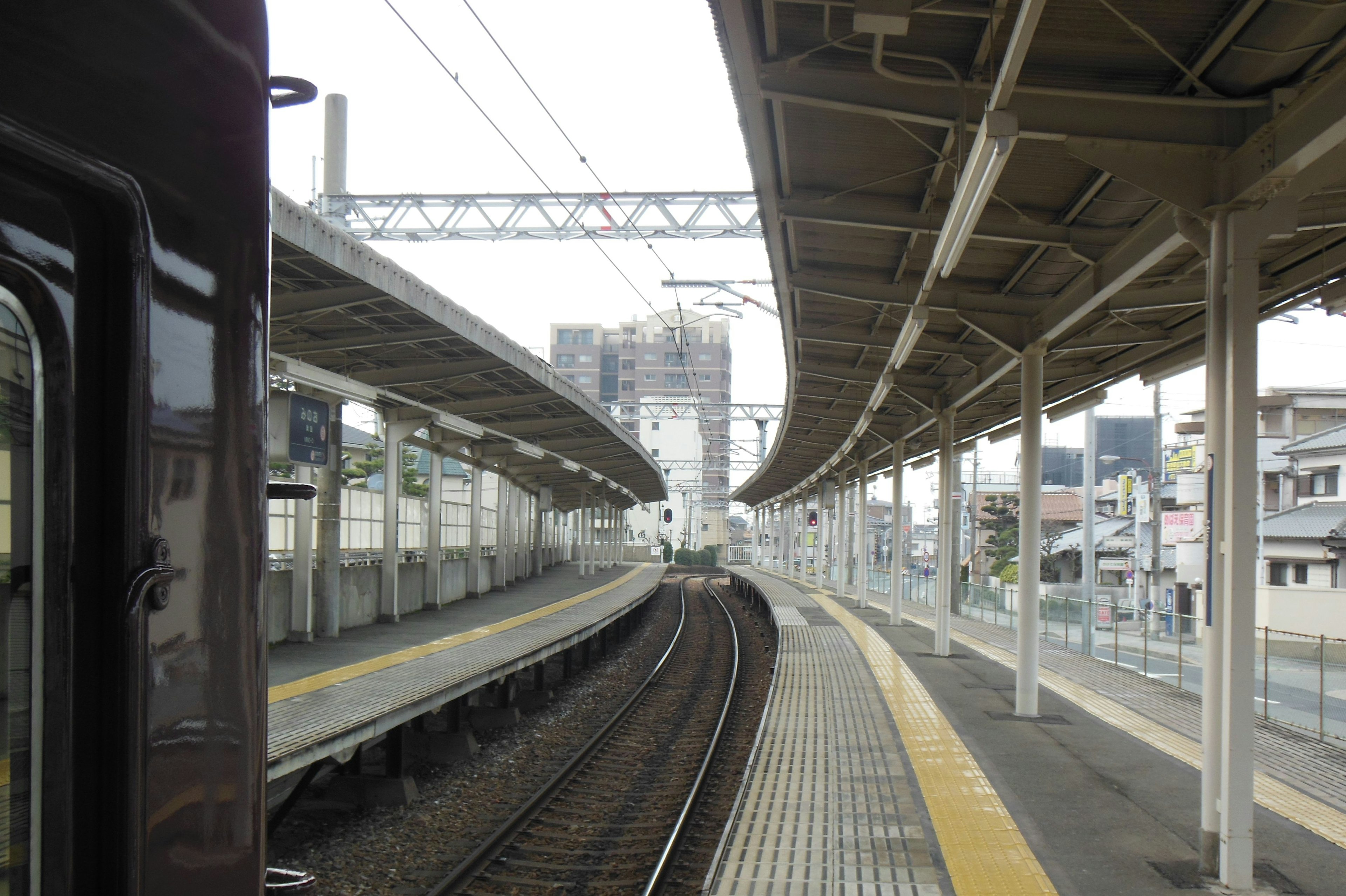 View of a train platform with curved tracks