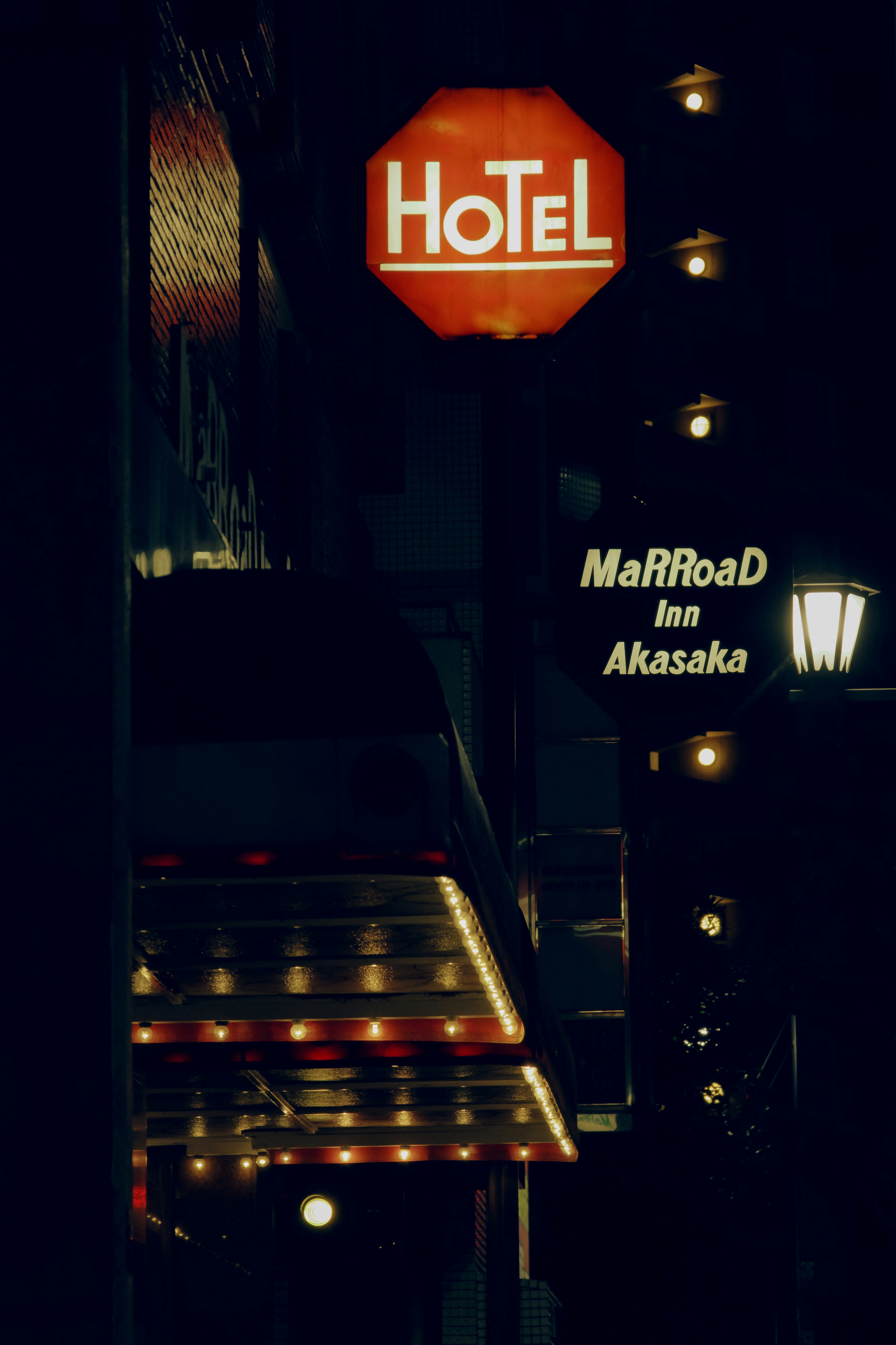 Illuminated hotel sign at night featuring Marriott Akasaka